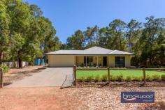 1355 Stevens St Mundaring WA 6073 $849,000 Discover the lifestyle offered by a versatile floor plan with a vast open-plan living area, an expansive outdoor entertaining zone, and the flexibility to allow for a fifth bedroom or a dedicated media room. Perfect for a growing family and occupying an unbeatable location, this beautifully presented home melds the tranquillity and natural beauty of the Perth Hills with the convenience of schools, sports and services on the doorstep. The home has been updated with timeless materials and colours fashioning an impressive family home. 4 bed + office space, 2 bath 1999-built brick and iron Media room or 5th bedroom O-plan kitchen/family/meals Outdoor living w built-in bar Ducted reverse cycle air con 108 sqm powered workshop Double carport auto door 2000 sqm level block Steps from Primary School This impressive property boasts four bedrooms, two bathrooms, a spacious open-plan kitchen family and meals area and high ceilings throughout. A separate junior wing, large home office and the flexibility for a media room or fifth bedroom make this a family home for now and years to come. High ceilings and generous proportions give the open-plan living zone a sense of grandeur, while swathes of natural light create an immediately inviting atmosphere. The kitchen is a cook’s dream with plenty of bench space, soft-close drawers, and quality appliances – a 900 mm Blanco oven, a 6-burner hob and a Bosch dishwasher. Uninterrupted movement between the central living zone and the expanse of outdoor entertaining space will delight growing families and those who love entertaining. Set under a high gable roof, the stretch of outdoor living boasts a built-in bar, sound system, retractable screens and ample room for seating, barbecuing and relaxing. The main bedroom sits at the front of the plan, offering a serene oasis with a soft neutral palette, new carpet, a walk-in robe, and a fully tiled ensuite. A separate junior wing arranged off the central living area comprises three bedrooms with new carpet and mirrored built-in robes. A stylish, fully tiled family bathroom with a walk-in shower and vanity and a walk-through laundry with ample storage and a separate WC complete the layout of the junior wing. The fully fenced block features reticulated gardens and a peaceful, relaxing setting in a family-friendly neighbourhood. There is plenty of room for kids and pets to run and play. If you work from home, the spacious office inside the front door gives you a dedicated workspace away from the activity of the central living zone. Those who love to tinker will find inspiration in the large, powered workshop set towards the rear of the block. A two-bay carport – in addition to the double garage under the main roof – a wide sliding door, separate storage area and drive-in access ensure plenty of room for tools, vehicles and equipment. This property is an idyllic place to call home, situated in a peaceful, family-friendly neighbourhood, steps from the Mundaring Primary School and minutes from the bustling Mundaring Village. The Heritage Trail, sporting facilities and access to the airport are all within easy reach of the fully fenced 2000 sqm lot. Don’t wait to discover the magic of a Hills lifestyle.