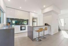 2/5 Clarendon Street Frankston VIC 3199 $670,000 - $737,000 Sparing no expense over two storeys with quality fixtures and finishes and a focus on easy living, this superbly appointed three-bedroom contemporary townhouse delivers carefree comfort in the beating heart of beachside Frankston. Flooded in radiant natural light, spacious interconnected living and dining flows out through glass doors to a private courtyard garden, while an impressive cook's kitchen delights with a waterfall-edge stone breakfast peninsula, gas cooktop, stainless-steel oven, integrated dishwasher and smoky mirrored splashback. Plush carpeting and day-and-night roller blinds adorn all three bedrooms, which are served by a contemporary master ensuite on the lower level and a full modern bathroom upstairs with a bathtub, shower, floating vanity and separate toilet. A study nook with built-in desk, high ceilings with LED lighting, ceramic tiling in the living room and wet areas, fresh tones, ducted heating and a single garage are among the inclusions of this turnkey residence, which will suit starters, investors, couples and families equally. A walkable distance to the train station, beach, Bayside Shopping Centre, restaurants, cinemas, the hospital, Homemaker Centre, Monash University, Chisholm and Frankston Primary School in the Frankston High School zone, this property also ticks every single box for savvy investors.
