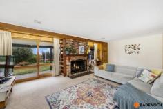 16 Adamson Cres Wanniassa ACT 2903 $949,000 Situated in an elevated position with sweeping views of the Brindabella's from the front, this lovely 3-bedroom home is set amidst mature gardens in the sought-after Wanniassa Heights. Set back privately on the large block or 1,101sqm, the front yard is fenced and private with a generous lawn area & a pergola-covered paved entertaining area, all taking in the panoramic views of the mountains ranges. Full-length verandahs flank the front & rear of the home, providing further spots to enjoy the view undercover as well as keeping the house cool and shaded in summer. Entering the home, you are greeted by the spacious lounge and dining area with a fireplace surrounded by a brick hearth for cozy winter gatherings. The light and airy updated kitchen has plenty of storage, an island bench & modern appliances including a dishwasher, & seamlessly adjoins onto a sunny tiled family area. Sliding doors provide access to the private rear garden which features lovely stone retaining walls. All 3 bedrooms are well-sized, two with the convenience of built-in robes & the family bathroom with a skylight plus separate toilet for added comfort. Original timber design features throughout the home add a warm look to the home and include timber-framed windows and timber sliding doors in every room. Wanniassa is popular with families for its established leafy streets, big blocks and a great community feel. It is within walking distance to Erindale shops, cafes and schools and only ten minutes’ drive to Tuggeranong or Woden. Features of the home include; 3-bedroom home Elevated block of 1,101sqm Built-in robes to 2 bedrooms Central family bathroom with separate toilet Large separate laundry with direct outdoor access Tiled family area with sliding door access to back yard Ducted reverse cycle air conditioning Modern kitchen with dishwasher and plenty of cupboard and bench space Double garage with remote Views of Brindabella's from the large enclosed & private front yard Spacious yard, ready for entertaining with pergola with BBQ & lawn area