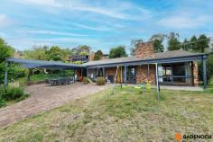 16 Adamson Cres Wanniassa ACT 2903 $949,000 Situated in an elevated position with sweeping views of the Brindabella's from the front, this lovely 3-bedroom home is set amidst mature gardens in the sought-after Wanniassa Heights. Set back privately on the large block or 1,101sqm, the front yard is fenced and private with a generous lawn area & a pergola-covered paved entertaining area, all taking in the panoramic views of the mountains ranges. Full-length verandahs flank the front & rear of the home, providing further spots to enjoy the view undercover as well as keeping the house cool and shaded in summer. Entering the home, you are greeted by the spacious lounge and dining area with a fireplace surrounded by a brick hearth for cozy winter gatherings. The light and airy updated kitchen has plenty of storage, an island bench & modern appliances including a dishwasher, & seamlessly adjoins onto a sunny tiled family area. Sliding doors provide access to the private rear garden which features lovely stone retaining walls. All 3 bedrooms are well-sized, two with the convenience of built-in robes & the family bathroom with a skylight plus separate toilet for added comfort. Original timber design features throughout the home add a warm look to the home and include timber-framed windows and timber sliding doors in every room. Wanniassa is popular with families for its established leafy streets, big blocks and a great community feel. It is within walking distance to Erindale shops, cafes and schools and only ten minutes’ drive to Tuggeranong or Woden. Features of the home include; 3-bedroom home Elevated block of 1,101sqm Built-in robes to 2 bedrooms Central family bathroom with separate toilet Large separate laundry with direct outdoor access Tiled family area with sliding door access to back yard Ducted reverse cycle air conditioning Modern kitchen with dishwasher and plenty of cupboard and bench space Double garage with remote Views of Brindabella's from the large enclosed & private front yard Spacious yard, ready for entertaining with pergola with BBQ & lawn area