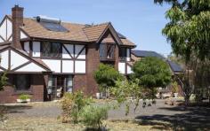 606 Dripstone Rd Dripstone NSW 2820 $975,000 A slice of old England in Dripstone This beautiful Tudor style home located in the undulating hills of Dripstone, set on a 2.6-hectare or roughly 6.4-acre property. The property's location in the hills of Dripstone offers a serene and peaceful environment, allowing you to escape the hustle and bustle of town. The large property size provides ample space for outdoor activities, such as gardening or hosting outdoor events. The Tudor style of the home adds to its charm, providing a unique and distinctive look that sets it apart from other homes. The downstairs area of the home boasts four spacious reception rooms, including a theatre room, formal lounge, sitting room, and a large dining room. The theatre room features cathedral ceilings, adding to its grandeur and providing an excellent space for entertaining guests or relaxing with family. The sitting room opens out to a tiled outdoor area, creating an ideal space for outdoor dining or relaxing in the fresh air. The outdoor area is perfect for entertaining guests, especially during the warmer months. This home also features an office, located just as you walk in, providing a private and quiet workspace that is separate from the rest of the living areas. This is an excellent feature for those who work from home, providing a dedicated space to focus and be productive. The views of the garden will add to your workday. The kitchen has been beautifully crafted from timber and features an island bench with ample storage, a convenient pull-out pantry, and a breakfast bar. The kitchen is equipped with a stove top and oven, both powered by LPG gas, providing an efficient and reliable cooking experience, it’s design and features make it a highly functional and convenient space, providing plenty of storage and bench space for meal preparation and cooking. The Ye Old touch and timber raked ceilings add character and a unique style to the home, making it stand out from other properties. This charming room opens out onto a delightful outdoor area, perfect for enjoying a morning coffee or outdoor dining. The laundry is very functional and has a toilet which is perfect for when you are entertaining. Overall, the downstairs area of the home provides ample space for relaxation, entertainment, and work. The various reception rooms and outdoor area provide flexibility in how the space can be used, catering to the needs of different members of the family. The four bedrooms are all located upstairs. Each of the bedrooms has a built-in robe, providing ample storage space for clothing and personal belongings. The master bedroom has been recently renovated and features a large built-in robe and a fully renovated ensuite bathroom. The ensuite includes a rainwater shower, separate wash basins with a marble top, and plenty of storage space, adding a touch of luxury and convenience to the master suite. Bedroom 2 is particularly charming, with an ornate bay window overlooking the front yard, providing plenty of natural light and a beautiful view. All the bedrooms upstairs have fully ducted evaporative air cooling, which also helps to keep the downstairs area cool during the summer months. In addition, the downstairs area features split systems, providing additional cooling options for the warmer seasons. The main bathroom is located upstairs and is well-appointed, featuring a bath and a separate shower, providing flexibility for the family's bathing preferences. The bathroom also includes a vanity just outside the bathroom, providing a convenient space for grooming and getting ready for the day without interfering with those using the bathroom. This home is equipped with several eco-friendly features, which not only help reduce the carbon footprint of the property but also offer significant cost savings to the owners. The home has a solar hot water system installed, which utilizes renewable energy from the sun to heat the water for the property. In addition, the property has a 4.2 kW solar system with 15 kW storage, which generates electricity for the home and significantly reduces energy costs. The energy generated by the solar panels can be stored in the batteries for later use, providing a reliable and sustainable source of power. The property also benefits from minimal rates and no water costs, making it an attractive option for those looking to save on household expenses. Overall, the eco-friendly features of the property offer a sustainable and cost-effective living solution for the new owners, allowing them to enjoy a comfortable and environmentally conscious lifestyle. The property features three garages, including two two-car garages and a three-car garage with a hoist. More pictures available on request. The outside area has many beautiful lifestyle features – These include. o Bore for outside water and underground sprinklers. o 90,000 concrete water tank for house use o 30,000 poly tank as back up o Solar hot water o 4.2 KW solar system with 15 kw storage o Separate greenhouse o Established gardens including Pears, Oranges, Mandarins, Cumquat, Lemon, Fig, Chilli, and quince. o 2 x two-car garages and a three-car garage with hoist o Small Dam filled with yabbies o Alarm Systems on the garages o CCTV on the house o Electric gate opening