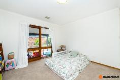 16 Adamson Cres Wanniassa ACT 2903 $949,000 Situated in an elevated position with sweeping views of the Brindabella's from the front, this lovely 3-bedroom home is set amidst mature gardens in the sought-after Wanniassa Heights. Set back privately on the large block or 1,101sqm, the front yard is fenced and private with a generous lawn area & a pergola-covered paved entertaining area, all taking in the panoramic views of the mountains ranges. Full-length verandahs flank the front & rear of the home, providing further spots to enjoy the view undercover as well as keeping the house cool and shaded in summer. Entering the home, you are greeted by the spacious lounge and dining area with a fireplace surrounded by a brick hearth for cozy winter gatherings. The light and airy updated kitchen has plenty of storage, an island bench & modern appliances including a dishwasher, & seamlessly adjoins onto a sunny tiled family area. Sliding doors provide access to the private rear garden which features lovely stone retaining walls. All 3 bedrooms are well-sized, two with the convenience of built-in robes & the family bathroom with a skylight plus separate toilet for added comfort. Original timber design features throughout the home add a warm look to the home and include timber-framed windows and timber sliding doors in every room. Wanniassa is popular with families for its established leafy streets, big blocks and a great community feel. It is within walking distance to Erindale shops, cafes and schools and only ten minutes’ drive to Tuggeranong or Woden. Features of the home include; 3-bedroom home Elevated block of 1,101sqm Built-in robes to 2 bedrooms Central family bathroom with separate toilet Large separate laundry with direct outdoor access Tiled family area with sliding door access to back yard Ducted reverse cycle air conditioning Modern kitchen with dishwasher and plenty of cupboard and bench space Double garage with remote Views of Brindabella's from the large enclosed & private front yard Spacious yard, ready for entertaining with pergola with BBQ & lawn area