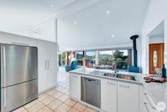 13 Amaroo Crescent Fingal Bay NSW 2315 If you are looking for an exceptional family home in a magnificent Fingal Bay location, look no further than this impressive residence of generous proportions. Privately set back from the road and basking in the beauty of a serene National Park aspect with views across the pristine Fingal Bay Beach, prepare to fall in love with this beautiful home. Inside, cathedral ceilings and unique angled architecture emphasise the space of the open floor plan and provide plenty of room for the family to relax, work or enjoy. An array of glass sliding doors allow for a seamless transition of indoor and outdoor entertaining from the spacious living and dining room, out onto the sundrenched balcony where you can enjoy a peaceful sundowner to the sound of bird song. A considered layout cleverly utilises multiple living zones spanning over two levels to create an uncompromised lifestyle of luxury and comfort. Drenched in natural sunlight, the grand master suite includes an oversized walk-in wardrobe, split system air-conditioning and a beautifully renovated ensuite bathroom, fit with a sumptuous spa bath and separate shower. Three generous bedrooms with built in wardrobes complete the accommodation on the upper level and are all centrally located to the functional three way bathroom. Positioned as the central hub of entertaining, a gourmet kitchen fit for the astute chef is complimented by spectacular gloss white cabinetry, an impressive stone bench with breakfast bar and is fit with quality appliances making your next celebration a breeze to cater for. Providing all the modern conveniences of todays day and age, an oversized second living space; designed to be transformed into a teenagers retreat, games room or separate living accommodation, occupies the lower level of the residence and includes a private study space and main bathroom for added advantage. Complete with a massive and easily accessible under house storage space, a large triple car garage; suitable for three vehicles and storage of small household items, two carports and bonus off-street parking - this property is all that you have ever dreamt of! Conveniently located approx. 800m to Fingal Bay Beach, popular cafes and restaurants and mere footsteps from the National Park should you wish to explore the bush walking paths or mountain bike trails, you are in the heart of it all here.