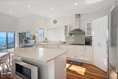 14A Christmas Bush Avenue Nelson Bay NSW 2315 Positioned in one of Port Stephens most highly coveted streets and located approx. 100m to the pristine shores of Dutchman's Beach, this prestigious residence delivers the perfect fusion of grand proportion and luxurious appointments to form an enviable lifestyle. The setting is serene - secure automatic gates open to reveal tastefully landscaped grounds with a divine blend of easy-care plants, lush greenery and stone accents, creating your own tranquil escape. Take advantage of those hot summer afternoons and take a dip in your plunge pool after a walk along the waterfront. Internally, the home is a breath taking blend of coastal elegance and contemporary luxury. Filled with distinct charm, the versatile floor plan cascades over three levels and creates sweeping open spaces where you can enjoy the exclusivity of this prime address. A masterpiece of indoor and outdoor living, each feature of the home is more enticing than the last, an array of louvered windows and glass sliding doors drench the rich timber floors and accentuate the space on the upper level. A striking sunlit deck overlooks the stunning blue vistas and adjoins the indoor dining space to create the perfect indoor-outdoor flow. Be the envy of your guests as you prepare decadent meals from your sumptuous culinary kitchen, fit with quality integrated appliances and a beautiful stone benchtop. Governing its overall vision and completing the upper level of the home, a bespoke master suite includes a lavish ensuite bathroom and offers ultimate privacy from your family and guests. Ensuring that space is never compromised, a second living space flows directly out onto the private outdoor alfresco where you can watch the kids splash in the pool from your choice of shaded and sunlit deck spaces, an additional two bedrooms of accommodation; each with built in wardrobes and one with access onto a small courtyard and is central to the grand main bathroom including shower, bath and double vanity space. Exuding indulgence, the residence is complete with ducted air-conditioning, a spacious double garage and access to a private gate to lead you down the path and directly to the beach. Situated directly opposite Dutchman's Beach, spend your mornings walking along the beach or enjoy listening to the sound of birdsong as you walk down the pathway to the Nelson Bay CBD to grab a coffee!