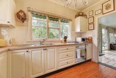73 Railway Ave Bundanoon NSW 2578 $1,195,000 This character 1950s weatherboard cottage set in a pretty Highlands garden will pull at your heart strings. Retaining all the charm of years gone with the modern conveniences one would expect. Easy level living plus a short stroll to village shops, cafes, station and school. High points Excellent northern aspect ensuring a warm sun filled home Three generous living spaces all of which flow seamlessly to one another and the newly renovated kitchen Vintage gas Aga is a highlight of the kitchen/dining space, perfect additional cooking appliance and warms the home Kitchen overlooks the front and side garden and has direct access to the sunroom and entertaining deck Cosy lounge also accesses both dining and sunroom via French doors and warmed via the slow combustion fireplace, a great winter room All three beds are generous in size and offer varying degrees of storage options from small cupboards to gorgeous ornate robes with built-in dressing table Both bathrooms are in good condition, the main bath houses a bath, shower, wc and pedestal vanity whilst the second bath also offers the European laundry Adding to the charm and convenience of the home is 9ft ceilings, timber floorboards, picture rails, split a/c in the family/kitchen space and all town services Externally the home offers a free standing studio, a great work from home space, a generous garden shed and a lovely paved rear terrace and pathway through the garden Parking is via the double carport with plenty of extra off street parking if needed Fully enclosed rear garden perfect for pets plus a lovely array of trees, shrubs and garden beds