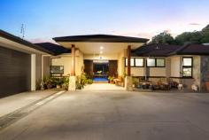 1 Vita Bella Court Currumbin Valley QLD 4223 “Vita Bella” is the essence of a beautiful life, and that's precisely what awaits with this single-level sanctuary. A former BoysTown Prize Home that backs onto an idyllic nature reserve, it sprawls across a lush 1 acre allotment to blend timeless allure with modern luxuries. Fresh, light-filled and north-facing, step inside and indulge in a symphony of elegance and comfort. A sleek and spacious kitchen with stone waterfall-edge island bench, stainless steel appliances and large walk-in pantry takes its place as the heart of the home, overlooking an expansive and open plan living and dining area. Here, full-height glass windows frame glistening pool views while an in-set gas fireplace adds cosy charm. There's also a media room to relax in, plus four bedrooms promise rest and rejuvenation. The master suite is particularly peaceful, with this private oasis tucked away from the remaining bedrooms. Infinitely indulgent, soak away any stress in the luxe spa while savouring valley views, or enjoy this scenic outlook from your exclusive-use deck. Outdoors, embrace effortless alfresco entertaining on the vast terrace or take advantage of the supersized, wraparound resort-style pool. Glorious established gardens surround the allotment in greenery, with a charming summer creek adding to the outside enchantment, winding its way through this fully fenced block. Nestled in a sought-after setting, this location radiates pure tranquillity. Meandering walkways line the creek edge, delivering you to the famed Pasture and Co Café at the Eco Village or local picturesque parks. In six minutes, arrive at Currumbin Fair or sample the sand and sea with Currumbin Beach, Palm Beach, and vibrant Burleigh Heads all within approx. 12-17 minute's drive. Add easy access to schools and the airport, and you'll soon see why this is “a beautiful life”! Arrange an inspection today. House Features Effortlessly modern single-level sanctuary Fresh and light-filled, with polished hardwood flooring throughout Portico entry, opens to a foyer via stately double doors, with immediate pool views Sleek and spacious kitchen with stone waterfall-edge island bench, large walk-in pantry and stainless steel appliances (including a 4 burner gas cooktop, built-in convection microwave and oven) Vast, open plan living and dining area with built-in cabinetry, feature wall with in-set gas fireplace and full-height glass windows framing pool views Media room Oversized master suite with walk-in robe with built-in cabinetry, private deck overlooking lush acreage and a contemporary ensuite with double vanity, double shower and luxe spa Three bedrooms with built-in robes, two with access outdoors Study nook with built-in desk Elegant three-way main bathroom Powder room Tiled alfresco entertaining area accessed via bi-fold doors, overlooking pool with sunshades, fan, and lighting Supersized, wraparound resort-style pool Laundry with ample storage Double garage with storage Ducted air-conditioning throughout Property Features North-facing on a lush 1 acre allotment, backs onto a beautiful nature reserve Former BoysTown Prize Home Summer creek meandering through the grounds Fully fenced, with electric entrance gate Side access gate and additional parking Water tank Envirocycle Raised vegetable gardens Greenhouse Double bay work-shed with power Location Approx. 5 mins from IGA/Currumbin Fair Approx. 6 mins from St. Augustine's Parish Primary School Approx. 10 mins from Currumbin Beach Approx. 12 mins from Palm Beach Approx. 15 mins from Gold Coast Airport Approx. 17 mins from Burleigh Heads Approx. 37 mins from Surfers Paradise
