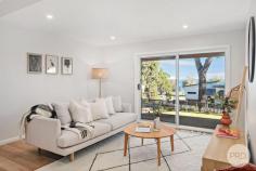 13 Cromarty Road Soldiers Point NSW 2317 Delivering a commanding street appeal, this impeccably transformed residence delivers a low maintenance, high-end sanctuary for both families and downsizers, offering unbeatable comfort and sophistication with a prestigious beachside address. Situated a mere 150m to the glistening water of Sunset Beach and renovated to the highest standard, there is absolutely nothing left for you to do except turn the key, move in and start enjoying your dream lifestyle. Cleverly designed to deliver a striking coastal home, the upper-level comprises a vast open plan living & dining area enhanced by quality timber flooring and a seamless transition to a sun bathed balcony perfect for enjoying breezy afternoons with family and friends as you admire the water views on offer not to mention the most stunning Sunsets. An additional living area downstairs makes the perfect retreat for the kids and means you never have to compromise on space! The gourmet kitchen is equipped with a quality stone benchtop, premium induction cooktop, LED feature lighting & breakfast bar which is finalised by shaker style cabinetry for a sleek, modern look. Accommodation is comprised of four generously proportioned bedrooms including a master suite with a walk-in wardrobe & ensuite bathroom. Featuring split system air-conditioning, skylights, water views, energy saving LED lighting throughout, immaculate landscaping with watering system, single garage plus an extra carport- this residence is sure to impress! Spend your mornings walking along the beach or enjoy listening to the sound of birdsong as you walk down to local cafes to grab a coffee or a delicious meal!