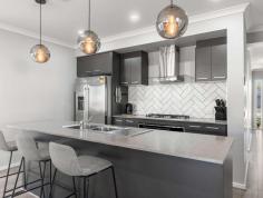 29 Noble Circuit Hackham SA 5163 $575,000 - $610,000 Completed in 2020, this exquisite four-bedroom home showcases contemporary designs, featuring a remarkably spacious and functional floorplan. The layout encompasses open plan living and dining areas, a family room with a dedicated study nook, and a generously proportioned outdoor entertainment space. Situated in a highly accommodating neighbourhood, in close proximity to local amenities such as shops and schools, this property presents an ideal opportunity for first home buyers, growing families, and investors alike. Upon entering the home, we are greeted by the stunning wooden flooring and expansive picture windows in every room with a warm and inviting ambiance. To the right, the beautiful master bedroom offers ample space for personal customisation. The master suite is equipped with a spacious and practical walk-in robe and ensuite, featuring a large walk-in shower, generous double vanity, and toilet. Bedrooms 2, 3, and 4 are all fitted with built in wardrobes for ample storage space. The floorplan is intelligently designed, with all bedrooms conveniently located in close proximity to the main bathroom and laundry facilities. The bathroom has a simplistic and chic aesthetic, with dark grey flooring complemented by white wall tiling, cabinetry, and fixtures. It includes a full-sized bathtub, walk-in shower, separate toilet, and ample cupboard space to meet all storage needs. The open plan living and dining area serves as an ideal space for entertaining, seamlessly connecting to the outdoor entertainment area through glass sliding doors. The kitchen is truly stunning, featuring an abundance of black cabinetry, complemented by grey benchtops topped with three pendant lights and a white herringbone splashback. High-quality appliances include a large 5-burner gas cooktop with a rangehood, InAlto oven and dishwasher, while offering ample space for a French door fridge or microwave, along with plenty of storage options. The family room provides a cosy setting for enjoying quality time with loved ones, whether snuggled up on the couch for a rainy-day movie or seeking a peaceful space for study away from the rest of the home. For optimal temperature control throughout the year, the residence is equipped with ducted reverse cycle heating and cooling. Beyond the impressive interior, the exterior of the home is equally captivating. The front facade showcases a charming charcoal brick exterior, complemented by well-maintained gardens, while a double garage ensures secure vehicle storage. Ample driveway space and side access are also available for additional off-street parking requirements. The outdoor entertainment area is truly delightful, featuring a pitched pergola that allows for comfortable gatherings with extended family and friends throughout the year. The entire property is enclosed by high-quality fencing, providing both security and privacy. Additionally, there is ample grass area for children and pets to enjoy. Located in close proximity to local schools, gym and shopping centres, this property is a true gem. In addition to its outstanding features, here are some highlights: Open plan living area Master bedroom with walk-in-robe and en-suite Multiple living areas Double garage Solar electrical system with two battery backup Wireless pop-up irrigation Side access Ducted reverse cycle heating and cooling Metricon Built 2020 Bedroom 2, 3, & 4 fitted with robes Pitch pergola Garden Shed
