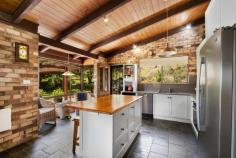 165 Translator Road Armidale NSW 2350 $1,350,000 Discover a peaceful and private rural paradise spanning 9.57 hectares, just a short 5-minute drive or bike ride from the CBD and airport. 'Applegum Ridge' is set on the fringe of the fast-growing town of Armidale, NSW. Armidale is located in the heart of the New England Region with easy access via road, rail, and air to metropolitan centres. Armidale is well-known for its proximity to world heritage national parks, excellent educational opportunities, including the University of New England and TAFE NSW Digital Hub. The main residence is a solar passive double brick building with four bedrooms, featuring built-in robes. The master bedroom comes with an ensuite, there is a three-way bathroom to service the other bedrooms. The living room boasts a soaring timber-clad vaulted ceiling and a cosy fireplace, while the kitchen combines country-style charm with modern appliances. The house is designed for solar passive heating in winter and cooling in summer, perfectly complementing the four-season garden. Outside, you can enjoy the landscaped garden, basalt stone walls, a waterfall, and a variety of deciduous trees, along with your very own olive grove. The property offers numerous entertaining areas with a patio and deck, providing great spots for relaxing with family & friends and enjoy the panoramic views. The property features four water tanks, a workshop/machinery shed, and well-maintained yards servicing six paddocks, suitable for horses and livestock enthusiasts. Additionally, there is a self-contained one-bedroom guest cottage that can be used as an office or extra accommodation. It features an open-plan kitchen, living, and dining area with new reverse-cycle a/c, as well as a bedroom, bathroom, and single carport. This tranquil retreat with sweeping rural views awaits your discovery. Don't miss your opportunity to own this 9.57ha rural paradise, offering both serenity and convenient town access.