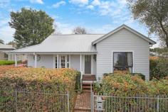 20 Ferguson St Cessnock NSW 2325 $530,000 - $550,000 – This charming weatherboard cottage is located in a popular street only a stones throw away from the centre of town – A full hedge and feature olive tree set the scene and invites you to the front door – Upon entering the home you are met by beautiful features of yesteryear with stunning timber flooring, high ceilings, dado rails, coloured feature glass and French Doors opening to the front and rear of the home – The two bedrooms are bright and generously sized, the second bedroom features an ornamental fireplace and A/C. Both bedrooms have ceiling fans – The colour scheme is fresh and bright throughout and a nod to the history of the home with feature painted rails in a heritage style colour – The easy flow floorplan offers a spacious living room in the middle of the home that continues through to the dining and kitchen – The practical kitchen is equipped with substantial storage, preparation space and a free-standing electric oven – The large bathroom really fits the feel of the home and there is a second toilet to the rear of the home near the internal laundry – The rear French doors open to the covered alfresco space that overlooks the captivating and picture perfect established gardens, a real feature of the home and a wonderful, private oasis! – There is a lock up garden shed that provided ample storage space for the tools and garden equipment – Externally there is nothing to do with the cottage having a full external paint and new colorbond roof – The package is finished off by a fully fenced yard on a 626m2 block with side access from the laneway – This is a property sure to catch attention with its charming style, so be sure to be quick!