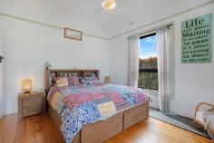 20 Ferguson St Cessnock NSW 2325 $530,000 - $550,000 – This charming weatherboard cottage is located in a popular street only a stones throw away from the centre of town – A full hedge and feature olive tree set the scene and invites you to the front door – Upon entering the home you are met by beautiful features of yesteryear with stunning timber flooring, high ceilings, dado rails, coloured feature glass and French Doors opening to the front and rear of the home – The two bedrooms are bright and generously sized, the second bedroom features an ornamental fireplace and A/C. Both bedrooms have ceiling fans – The colour scheme is fresh and bright throughout and a nod to the history of the home with feature painted rails in a heritage style colour – The easy flow floorplan offers a spacious living room in the middle of the home that continues through to the dining and kitchen – The practical kitchen is equipped with substantial storage, preparation space and a free-standing electric oven – The large bathroom really fits the feel of the home and there is a second toilet to the rear of the home near the internal laundry – The rear French doors open to the covered alfresco space that overlooks the captivating and picture perfect established gardens, a real feature of the home and a wonderful, private oasis! – There is a lock up garden shed that provided ample storage space for the tools and garden equipment – Externally there is nothing to do with the cottage having a full external paint and new colorbond roof – The package is finished off by a fully fenced yard on a 626m2 block with side access from the laneway – This is a property sure to catch attention with its charming style, so be sure to be quick!
