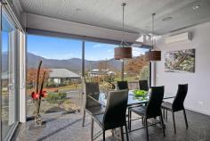 28 Fiddleback Drive Tawonga South VIC 3698 $1,500,000 - $1,600,000 Positioned in a picturesque Victorian High-Country valley is this extraordinary and ultra-modern home offering extensive unimpeded views of Mount Bogong and the Upper Kiewa Valley. This industrial themed and architecturally designed home features three bedrooms and two bathrooms with high end finishes, privacy, and elegance. Containing all the practicalities of modern living this property is set to impress and accommodate the demands of a wide range of purchasers. The breathtaking use of natural elements combine in a low maintenance front garden where slate stone flows featuring a dry creek bed with a modern fountain and gabion pillars which can be illuminated at night. An innovative above ground steel walkway reminiscent of a ski resort brings you to the remarkable entrance with a grand front door that welcomes you to this masterpiece of contemporary design unrivalled in scale, level of finish and sheer quality, this spectacular residence is unforgettable. This warm, luxurious tri-level home features extensive open plan living and is a banquet of bespoke design and detail with an industrial atmosphere comprising a lounge, kitchen, dining area and mezzanine above, all with stunning views of the surrounding countryside. The kitchen features top of the line appliances including an induction cook top on the large triangular island bench which has attached a glass breakfast bar. There is ample storage space in the kitchen with walk-in pantry, making it the perfect place for cooking and entertainment. The delightful adjacent dining area has an abundance of natural light from floor to ceiling tinted windows but transforms into an intimate and cosy dining area at night. Additional to the classic living areas there is a spacious upstairs mezzanine utilised as a sitting room offering spectacular unobstructed 180-degree views, day and night, of the Kiewa valley, Mount Bogong and the nearby township of Mount Beauty. A wonderful spot to sit and read a book or simply relax and drink in the view. Designed for grand scale alfresco entertaining the pool pavilion houses a heated 5-person spa, heated swim-jet pool with covers and a TV, perfect for all weather entertaining and being completely protected from the elements. The covered alfresco has an inside and outside counter connected to the kitchen by a bi-fold window to allow a seamless transition from indoor to outdoor living. It is an area that truly inspires and provides year-round poolside entertaining and an unparalleled lifestyle. The master bedroom is at the rear of the house and continues with the industrial and contemporary theme. Featuring a full room width, double access walk-in robe, an adjoining ensuite bathroom and large floor to ceiling windows looking out from the bedroom and ensuite over the large trees surrounding a flowing creek on the acreage behind the house. The subsequent two bedrooms are also substantial in size and have full width built-in robes. The third bedroom at the front of the house features large floor to ceiling window with spectacular views of the mountains. It is presently set up as a fully functional office/study but could be utilised as a bedroom if desired. The lowest level of the property is the most intricate containing a large workshop, garaging for 3 cars, a pool utility room containing washroom facilities and a room used as a garden shed with a separate entrance, all with concrete flooring and extensive built in cabinetry for storage facilities. Adjacent to the rear garage entrances is a large bituminous yard with ample space for a caravan, motor home or boat. The elegant gardens are low-maintenance with compact fruit trees and are auto drip irrigated for convenience. Additional features include, but are not limited to: • Double glazed windows throughout with large windows being lightly tinted with heat reduction and privacy film. • Instant hot water tap to a kitchen sink • Insinkerator in one kitchen sink • Professional reach and pull-out kitchen mixer tap • Extensive LED lights throughout • 30 solar panels with Tesla lithium battery backup • Home security alarm with outside video security cameras • Comprehensive audio-visual system with speakers and TV outlets throughout • 2x 6000litre rainwater tanks with submersible pump supplying water to toilets, laundry and some garden taps • Solar hot water service • Remote controlled automatic sliding gate to driveway entrance • Front bitumen driveway has additional off-street parking space • Garden shed under side of house • Large unused areas under floor of living area with potential for additional usable spaces for rooms or storage • Secure quality fencing for privacy The residence is situated on a small new estate with modern all underground services. The estate is 3km from Mount Beauty and is set in the middle of farmland and small acreages and is a mere 45 min drive from the snow at Falls Creek Ski Resort. The rural township of Tawonga is situated in the Kiewa Valley, North East Victoria in the Heart of the High Country. Tawonga is renowned for its majestic landscape and is central to a variety of recreational activities including fly fishing, horse riding, camping, water sports, downhill and cross-country skiing, snowboarding, golf, tennis, and mountain biking, bush walking, gliding, private aviation or simply absorbing nature. The region also boasts award winning restaurants and vineyards. The exterior of this property presents unique quality architecture, while the memorable interior spaces show an incomparable combination of sophistication, cutting edge design, and spectacular attention to details.