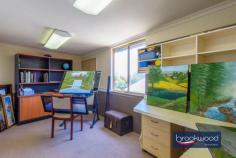 19 Oxley Pl Darlington WA 6070 $1.24 MILLION Dappled light dances along a quiet, secluded cul-de-sac leading to the carriage driveway of this large family home with breathtaking views, zoned living, expansive outdoor living and entertaining space, a separate studio and a below-ground pool with a gazebo. A quintessential Darlington property with exceptional views, the home boasts generous proportions, formal and informal living and views that sweep from Boya across the plains to John Forrest National Park. • 5 bedrooms 3 bathrooms • 1984-built brick and iron • Formal lounge and dining • Open-plan kitchen/meals • Activity/media w projector • W-around alfresco w blinds • Freestanding studio space • Heated below-ground pool • 2122 sqm dual frontage lot • Secluded Hillside location Step inside to discover generously proportioned living spaces that seamlessly blend formal and informal areas, all enhanced by breathtaking views with almost every window framing exceptional vistas and bringing the outdoors in with abundant natural light and beauty. A separate junior wing comprising three bedrooms and a family bathroom is arranged at the front of the plan, along with a study with an entry from the garage. An ensuite bedroom with a corner window capturing fantastic views across the pool to the horizon offers ideal accommodation for an adult child or older parent. This large, carpeted room boasts reverse cycle air conditioning, a renovated ensuite and built-in robes. Central to the expansive floorplan is a large media/activity room with a fixed screen, an overhead projector, speakers and ample space for a pool table. Suited for multiple uses, the activity room has exterior access and double doors leading to the family room, where a slow-combustion fireplace and reverse-cycle air conditioning create a family hub that is comfortable and inviting year-round. The bright, modern kitchen is filled with panoramic views thanks to glazing on three sides. Crisp white cabinetry, above and below a large, U-shaped countertop, surrounds an electric cooktop, oven, and dishwasher. A servery hatch makes alfresco dining and entertaining a breeze. Adjoining the kitchen is a formal dining room and lounge, calm and sophisticated rooms featuring corner windows framing various aspects of the view. The main suite sits at the northern corner of the plan. It consists of a study/sitting room that could be styled as a dressing room, a large bedroom with direct access to the alfresco entertaining area, a bay window looking across the paved verandah, an ensuite and a walk-in wardrobe. The outdoor living and entertaining areas are as impressive as the interiors, offering expansive spaces to host gatherings and revel in the stunning location. The home’s wide veranda gives the impression of floating in the panoramic view. It wraps the front of the home and offers multiple spaces for entertaining and relaxing. A separate studio provides versatility as a creative workspace, guest accommodation, or a teens’ retreat. Completing this idyllic setting is a heated below-ground salt pool edged with a cabana and lawn. An atmosphere of welcome and generosity makes this a home where everyone wants to be. The kids and their friends will love the pool and yard, guests will be mesmerised by the views from the indoor and outdoor entertaining areas, and everyone will appreciate the media room with its large screen and projector, taking ‘Netflix and Chill’ to a new level. This is more than a home; it’s a haven where you can savour the best of Darlington living with unmatched style, views, and tranquillity. Around twenty minutes from Perth airport and thirty-five minutes from the CBD, this home is ideally located for commuting and offers easy access to a choice of schools.