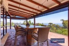 19 Oxley Pl Darlington WA 6070 $1.24 MILLION Dappled light dances along a quiet, secluded cul-de-sac leading to the carriage driveway of this large family home with breathtaking views, zoned living, expansive outdoor living and entertaining space, a separate studio and a below-ground pool with a gazebo. A quintessential Darlington property with exceptional views, the home boasts generous proportions, formal and informal living and views that sweep from Boya across the plains to John Forrest National Park. • 5 bedrooms 3 bathrooms • 1984-built brick and iron • Formal lounge and dining • Open-plan kitchen/meals • Activity/media w projector • W-around alfresco w blinds • Freestanding studio space • Heated below-ground pool • 2122 sqm dual frontage lot • Secluded Hillside location Step inside to discover generously proportioned living spaces that seamlessly blend formal and informal areas, all enhanced by breathtaking views with almost every window framing exceptional vistas and bringing the outdoors in with abundant natural light and beauty. A separate junior wing comprising three bedrooms and a family bathroom is arranged at the front of the plan, along with a study with an entry from the garage. An ensuite bedroom with a corner window capturing fantastic views across the pool to the horizon offers ideal accommodation for an adult child or older parent. This large, carpeted room boasts reverse cycle air conditioning, a renovated ensuite and built-in robes. Central to the expansive floorplan is a large media/activity room with a fixed screen, an overhead projector, speakers and ample space for a pool table. Suited for multiple uses, the activity room has exterior access and double doors leading to the family room, where a slow-combustion fireplace and reverse-cycle air conditioning create a family hub that is comfortable and inviting year-round. The bright, modern kitchen is filled with panoramic views thanks to glazing on three sides. Crisp white cabinetry, above and below a large, U-shaped countertop, surrounds an electric cooktop, oven, and dishwasher. A servery hatch makes alfresco dining and entertaining a breeze. Adjoining the kitchen is a formal dining room and lounge, calm and sophisticated rooms featuring corner windows framing various aspects of the view. The main suite sits at the northern corner of the plan. It consists of a study/sitting room that could be styled as a dressing room, a large bedroom with direct access to the alfresco entertaining area, a bay window looking across the paved verandah, an ensuite and a walk-in wardrobe. The outdoor living and entertaining areas are as impressive as the interiors, offering expansive spaces to host gatherings and revel in the stunning location. The home’s wide veranda gives the impression of floating in the panoramic view. It wraps the front of the home and offers multiple spaces for entertaining and relaxing. A separate studio provides versatility as a creative workspace, guest accommodation, or a teens’ retreat. Completing this idyllic setting is a heated below-ground salt pool edged with a cabana and lawn. An atmosphere of welcome and generosity makes this a home where everyone wants to be. The kids and their friends will love the pool and yard, guests will be mesmerised by the views from the indoor and outdoor entertaining areas, and everyone will appreciate the media room with its large screen and projector, taking ‘Netflix and Chill’ to a new level. This is more than a home; it’s a haven where you can savour the best of Darlington living with unmatched style, views, and tranquillity. Around twenty minutes from Perth airport and thirty-five minutes from the CBD, this home is ideally located for commuting and offers easy access to a choice of schools.