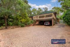 3 Carawatha Rd Parkerville WA 6081 $699,000 Positioned at the top of a sweeping paved driveway, nestled amongst parks and a reserve where dappled sunlight is filtered through ancient trees and wildflowers weave a tapestry of nature’s beauty, this Parkerville home is a symphony of threes. Three interconnected living areas, three bedrooms and three outdoor living and entertaining zones. • 3 beds 1 bath 2 WC • 1979-built brick & tile • Formal lounge/dining • OP kitchen/fam/meals • Main bed semi ensuite • 3 outdoor living zoned • Paved drive to carport • Gate to Reserve • 1912 sqm elevated lot • Walk to Parkerville Pub • With its elevated position and natural setting, this Parkerville home has the air of a mountain chalet and will enchant the hearts of those who believe in the magic of threes. North-facing decks and a wide, sheltered patio provide ample space for alfresco living and entertaining; a gate in the rear fence offers direct access to Reserve, Yennerdin Park is at the end of the street, and a path leads through Brookside Park for a seven-minute walk to the Parkerville Pub. The home is bright and welcoming with a formal lounge and dining room looking across a deck to the north, a kitchen/meals/family room offering a sociable space for informal entertaining and living and a multi-purpose library/media room with lots of built-in storage and an east-facing window framing a painterly scene of eucalypts and grass trees. The kitchen boasts overhead and under-bench storage, a freestanding oven, a dishwasher and an integrated breakfast bar. Reverse cycle air conditioning provides summer cooling while a slow-combustion fire offers winter warmth and a place to gather and share stories and make memories with family and friends. Two junior bedrooms sit at the rear of the plan while the main bedroom – a generously proportioned room – sits at the front of the layout with fabulous north-facing views, a large built-in wardrobe and semi-ensuite access to the family bathroom. The fully fenced backyard has direct access to Reserve, the front yard is all about the views and peaceful bush setting of two large decked entertaining areas. The first extends from the front of the home and is partially sheltered under a gabled roof. The second is nestled towards the front of the lot at the end of a winding path. Surrounded by a Colorbond fence and bosting a light-strewn gazebo this large open space is a wonderful space for play and entertaining. With a quintessential Hills setting and easy access to the local school pub and nearby Mundaring, this House of Threes stands as a testament to harmony and balance. It is a place where dreams flourish and laughter echoes, creating a fairy tale haven for those lucky enough to step through its doors. To arrange an inspection of this property, call Ken Wiggins on 0403 012 950
