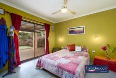3165 Victoria Rd Hovea WA 6071 $949,000 Live connected to nature on this spectacular Hovea property located on the border of John Forrest National Park. Minutes from Hovea Falls and kilometres of walking and riding trails, the 3 bedroom 2 bathroom home sits in a natural landscape with a canopy-level balcony that makes it feel like a treehouse. Fruit trees, vegetable gardens, rainwater tanks, solar panels and a storage battery lighten your footprint while the availability of scheme services provides security. This mesmerising environment is an idyllic habitat for humans and creatures, and the appearance of resident kangaroos, Red Tail Black cockatoos, Boobook Owls, Quendas and Echidnas is a thrilling reminder of the richness and rare beauty of nature. 3 bedrooms 2 bathrooms 1984 built brick and iron Multiple living zones Indoor-outdoor floorplan N-facing tree-top balcony Pwd workshop auto retic 6 kW solar 9.7 kW battery Decked above-ground pool 2 ha block paved driveway Spectacular natural oasis Moving through the landscape to arrive at this Hovea home feels like ascending to another realm, a secret world where native flora and fauna and the rhythms of nature direct and enrich each day. Cocooned by a degree of self-sufficiency and with endless opportunities to play, explore and discover the natural environment; this property delivers the shelter of a warm and inviting home and the nourishment and inspiration of a stunning and unique Hills location. The home displays a modern organic vibe with predominately neutral material and colour palettes interrupted by bursts of rich, warm colours and the use of robust natural materials. A central open plan bathed in light from a skylight, flows seamlessly to a formal entertaining space – currently used as a music room – and a north-facing sunroom with full-height glazing. The sunroom opens onto the verandah spanning the front of the home to create an all-season, indoor-outdoor living space that appears to float in the treetops and views to the decked gazebo and sparkling swimming pool. An intrinsic connection to nature is seen across the home, in the granite feature wall behind the slow combustion fire, the tactile, organic form of wooden handles on the kitchen cabinets, and the smooth, textured surface and subtle colour shifts of slate floors. In the beating heart of this home lies an updated modern kitchen, replete with stone benchtops, a suite of stainless-steel appliances and abundant storage. The master suite is positioned discreetly at the front of the home with polished concrete flooring and sliding door access to a wide verandah. Complete with a walk-in robe and semi-ensuite connecting through to the living hub. The junior wing housing two large bedrooms, a light filled family bathroom and walk-through laundry is tucked to the rear of the home. A commitment to stepping lightly is evident across the property. Reticulated vegetable gardens, wicking beds, fruit trees, and a chicken run bring self-sufficiency. Scheme water is available, and power is connected. Still, rainwater tanks, solar panels and a storage battery reduce dependence on the grid, and a large, powered workshop with 3 open bays provides a practical space for at-home projects and repairs. With 4.94 acres to explore and John Forrest National Park, The Heritage Trail, Eagle’s View walk and Hovea Falls at the bottom of the driveway, days of adventure and wonder await. Bike and walking trails in the national park have been extended and subjected to considerable upgrades in recent months, with further improvements planned. More sedate pastimes can be found at the much-loved Parkerville Tavern, an easy, level walk away along the Heritage Trail. It is rare to find a property of this character, a home that meets the ideal of Hills living so completely with the space and freedom of a 4.94-acre lot, adjacent to a national park, within easy reach of schools and Mundaring Village yet shrouded in the blissful beauty of nature and a sense of isolation.