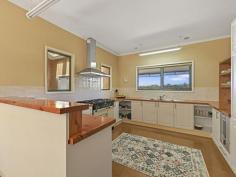 22 Landy Rd Foster VIC 3960 $720,000 Only a few minutes walk from the centre of town, this unique property enjoys the best of both worlds. Set on approximately 1051m2 of gardens with views out over the treed surrounds to the distant ranges with a wonderful connection to nature, with the convenience of all of the town amenities close by. Superbly maintained both inside and out with large rooms, high ceilings and large areas of glazing framing the delightful outlook. Open plan living room features polished timber flooring, wood heater and RC/AC. A spacious sunroom adjoins with a soaring ceiling, feature skylight and bi-fold glass doors leading out to a large covered entertaining deck, making this a flexible space that can be used to naturally heat and cool the home. The kitchen is a delight with country style cabinetry, feature recycled Oregon timber benchtops and the star of the show, a 'Falcon' 900mm dual fuel range with gas hob and double oven. There are three large fitted bedrooms, the master complete with a light filled ensuite. A centrally located main bathroom services the balance of the home and there is also a laundry / utility room with further storage. Outside the delights continue with established native plantings, winding paths to secluded spots to sit and reflect, raised vegetable beds, fruit trees, hot house, wood shed and lockup garage / workshop with direct access. Set on a quiet no through road with the bush reserve adjoining, this is a must see for anyone seeking peace and quiet.