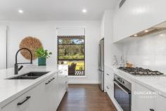 15 Heritage Dr Bundanoon NSW 2578 $3,000,000 - $3,300,000 Step into a world of unparalleled elegance and modern sophistication with this as-new, breathtaking home! A masterpiece of design, every inch has been crafted to offer a life of style without compromising practicality. Boasting five bedrooms, two expansive living areas, a stylish home office, and a kitchen that could grace the pages of Vogue, this residence is the epitome of luxury living. Indulge in the generous open-plan living and dining area, complete with a slow-combustion fireplace for cosy gatherings. Imagine double doors leading you into a spacious home office, while an impressive media room awaits with its very own walk-in bar. The deluxe kitchen features high-end appliances, stone surfaces, a breakfast island, and a butler's pantry – a culinary dream come true! Entertain effortlessly on the covered patio overlooking the expansive lawns and landscaped gardens, through to the newly established olive grove. The master bedroom is a sanctuary with a walk-in robe and an ensuite featuring a wet area and heated floor. Four additional bedrooms, each with built-in robes, offer private retreats. This residence is not just a home; it's an experience. From underfloor heating in the main and master bathrooms, to the integrated hampers in the laundry, every detail has been considered. Zoned controllable ducted heating and cooling provide comfort, while the secure double garage and internal alarm system offer peace of mind. The 21-panel solar energy system, ensures your power bills remain easy to manage. Nestled in 'The Yards of Bundanoon,' an exclusive estate, this home sits on a generous 1-acre parcel, promising a country locale synonymous with prestige and within walking distance of the village and railway station . Don't miss your chance to elevate your lifestyle – contact us now to make this extraordinary home yours! Other features include: Custom designed and built KENT Fairlight wood heater Electronically controlled Velux Westinghouse gas hob and large electric oven BOSCH dishwasher 9-foot ceilings Separate garden shed Security alarm 8 kWh solar energy Fully fenced back garden