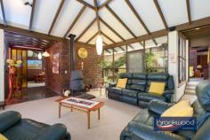 19 Cook St Darlington WA 6070 $779,000 Capturing the essence of 1970s design, this eye-catching family home showcases iconic features synonymous with the era – think exposed brick and beams, a raked ceiling and a floorplan revolving around a central atrium. The interior exudes warmth with its timeless timber built-ins and panels, complemented by the organic tones and texture of slate floors. This extraordinary home is now offered for sale for the first time in over five decades, presenting a unique opportunity to infuse new life and modernity. 3 bedrooms 2 bathrooms 1970’s built home Raked ceilings exp beams Extensive built-in storage Upstairs flexible living room Ducted vacuum system Powered work space + woodshed Paved drive double carport 2340 sqm elevated block Walk to Helena College Step through the grand double doors into a formal foyer, where slate flooring sets the tone for authentic 70s style. To one side, a generously proportioned living area beckons, while on the other, a formal dining room and a well-appointed kitchen await. The living room is an ode to relaxed sensibilities; it features a soaring raked ceiling adorned with exposed beams. Dual-aspect glazing fills the airy space with light and provides a view of the central atrium and the front garden. A slow-combustion fireplace and reverse-cycle air conditioning ensure year-round comfort, creating a harmonious blend of style and functionality. The formal dining room, with windows looking onto the atrium, leads into the kitchen and breakfast nook overlooking the front garden and surrounding natural landscape. The kitchen has electric appliances and boasts a large built-in pantry and split system air conditioning. A short flight of stairs leads from the living room to the main bedroom, a good-sized space looking onto the atrium with built-in storage and an ensuite with a shower, vanity and WC. The junior bedrooms, a study nook, and a family bathroom complete the bedroom zone layout. Both minor bedrooms have built-in storage and raked ceilings and benefit from a second slow-combustion fireplace. The flue of this second fireplace extends into the upstairs living area, a flexible area with multiple uses. The spacious second-storey extension with north-facing windows, built-in cabinets, and a wet bar is an ideal family room, guest accommodation, or teens’ retreat. It is not impossible to see this space transformed into an indulgent parents’ retreat with enviable tree-top views. Access to the under stairs wine cellar located on the exterior of the home, adds to the charm and a great use of space with built in wine bottle holders. The home is paved on all sides with a courtyard area to the southern side where you can settle in and enjoy the afternoon glow of the sun setting through the trees. A small, powered workspace sits at the top of the block. A space where your ideas and hobbies can come to life. Such a versatile area or can purely be used for extra storage and gardening tools. A woodshed located to the side with a lean-to roof, designed to keep yourself and the wood dry through the winter months. This move-in-ready property presents a canvas of possibilities with a coveted Darlington address, original features and a flexible floorplan, extending an invitation to reimagine the home’s potential. To those with a discerning eye, the intact seventies features offer a springboard to create a truly striking Hills home. Seize the moment to embark on a journey of renewal, establish a presence in this highly sought-after locale and embrace contemporary living in a fusion of iconic design and modernity.