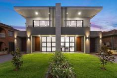 12 Moncrieff Dr East Ryde NSW 2113 $2,400,000 - $2,500,000 Defined by design that showcases quality and style, this expansive duplex has been thoughtfully imagined and impeccably crafted. The open concept living zone with seamless connection to the garden delights as an entertaining space, while the upstairs accommodation including magnificent owners' suite is a serene haven. Tucked on a quiet street, it's just steps to Wallumatta Nature Reserve and city buses, 400m to sought-after Ryde East Public School, with Macquarie Park and Top Ryde City shops minutes away. - Designed for a modern relaxed lifestyle with flowing living spaces - Bathed in light and connected to the outdoors by oversized windows - Luxurious kitchen complete with butlers' pantry and island seating - Primary bedroom boasts balcony, dressing room, ensuite with skylit bath - Three additional bedrooms upstairs with built-ins, extra lounge space - Flexible media room/home office or fifth bedroom on main level - Well zoned for guests with full bath on each level plus main ensuite - Stylish finishes include marble tiles, timber floors, brass tapware - Internal access to secure garage, ducted air conditioning throughout - In catchment for excellent schools, city bus departs near front door