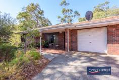 1 Darlington Rd Darlington WA 6070 $549,000 The surprise and delight of this spacious duplex with a flowing floor plan and large backyard make it a compelling opportunity to gain a foothold in the Perth Hills. The neat home sits on an elevated block looking out to a nature reserve, a situation that delivers a daily dawn chorus courtesy of the abundant bird life. Subtle 70s features, an idyllic location, a corner block and a no-fee duplex with a garage combine in an exceptional property. 3 beds 1 bath 2 WC Brick & tile duplex Spacious bedrooms Flowing floorplan OP Kitchen/meals E-facing verandah Expansive backyard Garage w shoppers 1339 sqm crn block A rare opportunity The front door opens into a comfortable, well-proportioned lounge room with a picture window framing classic Hills’ views from its elevated position. A sheltered front porch offers a similar perspective and the perfect spot for morning coffee. A clinker brick feature wall introduces a touch of 70s authenticity and partially separates the lounge from the open-plan kitchen/meals area. The meals area has ample room for a table, and the kitchen is defined by a worktop and integrated breakfast bar atop under-bench cabinets. An electric oven, grill, and hotplates ensure a functional space with plenty of room to cook up a storm. A sliding door leads from the meals area to the shelter of the large back verandah and yard. A door from the kitchen opens into a spacious walk-through laundry with built-in storage, a separate WC and a shoppers’ entry to the single garage. The family bathroom and three bedrooms are arranged at the north of the plan. The front and rear bedrooms are generously proportioned with built-in or walk-in robes, carpet and ceiling fans. The bedroom at the front of the plan boasts a picture window framing aspects of the garden and reserve. The rear bedroom looks out to the backyard. The family bathroom has a shower tub, vanity, and WC. The home’s garage opens directly into the laundry – a practical and surprising feature in a duplex unit of this vintage. This home sits on over 1339 sqm of land, with the potential for a second access point from Mitchell Road. Approval of the additional access could, in turn, allow for the construction of a workshop or storage space for a caravan or boat. This duplex feels like a detached home and represents an ideal proposition for first-home buyers wanting to get a foot in the Perth Hills or downsizers who still want to have room to garden and space for visitors.