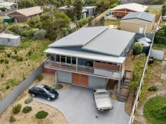 44 Myrica Street Primrose Sands TAS 7173 $745,000 Nestled in a private street within the picturesque coastal community of Primrose Sands, this contemporary home embodies the essence of beachside living. Perched in an elevated position, this spacious family residence offers breathtaking water views of Norfolk Bay and Frederick Henry Bay. Upon stepping indoors from the expansive front veranda, you'll find a seamless blend of open-plan living, connecting the lounge-room, kitchen, and dining area. The high ceilings and highlight windows enhance the sense of space and light. A central hallway leads to a generously sized master bedroom with its own ensuite and captivating views. Additionally, there are three more large bedrooms, a central family bathroom, and a convenient study nook in the accommodation wing. At the rear of the home, discover the laundry, an additional toilet, and a sheltered second entertaining space. On the ground floor, a spacious garage, workshop, and storage area provide ample room for vehicles, tools, and water sports equipment. With fully fenced grounds and low-maintenance landscaping, this established property invites you to fully embrace the beach lifestyle, with swimming, kayaking, and fishing just moments away.