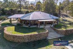 220 Tamma Rd Bakers Hill WA 6562 $775,000 Delivering more than you would expect, this Bakers Hill home gives you more than a dozen reasons to move to a lifestyle property. The 1.9 ha corner lot has good elevation, gently undulating topography, sheltered alfresco entertaining, fenced paddocks, a dam, and space to keep chickens. At the heart of this picture of rural bliss sits a Rural Building Company home positioned for views across paddocks to gently rolling hills at the horizon. 3 bedrooms 1 bathroom 2004-built brick and iron Open plan kitch fam meals Main bed w semi-ensuite Wrap around verandah Alfresco entertaining zone Swim spa & shady pavilion Pwd workshop solar panels 1.9 ha corner block w dam Designed for country living Occupying an elevated position towards the top of the block, this country home boasts a wrap-around verandah, multiple outdoor living and entertaining zones, and a relaxed, open-plan design. The front door opens into the open-plan living zone, a spacious central space with a bank of windows to the south, ceiling fans overhead, and timber-look floors. Reverse-cycle air-conditioning ensures year-round comfort. The kitchen is defined by a long benchtop set behind a half-wall made of exposed brick. Ample cabinets sit under granite-look benchtops, along with an electric oven and two-drawer dishwasher. A corner pantry and an electric cooktop complete the well-equipped and arranged kitchen. The main bedroom sits at the northeast corner of the plan and consists of a large bedroom, a walk-in wardrobe and semi-ensuite access to the family bathroom. A large, east-facing window framing classic rural views delivers an everchanging scene each morning. Two junior bedrooms with built-in robes, a walk-through laundry and a family bathroom, extend along the north of the plan. The laundry leads out to the shelter of a spacious alfresco living and entertaining zone. A second outdoor living space sits below the swim spa arranged off the front verandah. This sheltered pavilion with a concrete floor is open on two sides and offers ample space for poolside barbecuing. Fenced paddocks – one with a dam – a powered workshop with a concrete floor and covered hardstand, and a chicken coop and run set the stage for a rich and rewarding country lifestyle. Scheme water and space to plant vegetables and fruit trees broaden the canvas on which to draw a life connected to nature, responsive to the seasons and surrounded by the inimitable beauty of the Bakers Hill landscape. Minutes from the centre of town and the award-winning bakery and approximately halfway between Mundaring and Northam, this country property gives you space and freedom without sacrificing access to the services and amenities of town.
