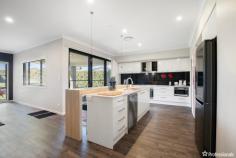 2 Burrell Court Armidale NSW 2350 $950,000 - $1,045,000 Welcome to 2 Burrell Court, a stunning family residence situated in the highly sought-after Foothills Estate of Armidale, perched high on North Hill. This prominent, oversized home offers the epitome of modern living with its thoughtful design and exceptional features. Boasting four spacious bedrooms, each equipped with built-in wardrobes, this home is perfect for a growing family. The master suite is a true retreat, featuring a generous walk-in wardrobe and a huge ensuite with a separate private toilet. Two additional bathrooms are strategically spread throughout the home, ensuring convenience and privacy for all family members and guests. Upon entering, you are greeted by a versatile front room that can easily be converted into a media room, home office, or visitor retreat, providing flexible living options to suit your lifestyle. The heart of the home is the expansive open-plan kitchen, dining, and living area. The modern kitchen is a chef’s dream, complete with an island bench, a walk-in pantry, a double-door fridge space with plumbed-in options, and gas cooking facilities. The dining and living areas are enhanced by elegant dark wood flooring and neutral tones, creating a warm and inviting atmosphere. Additional features of this impressive home include, a walk-in linen press for ample storage, double lock-up garage with internal access, ducted reverse cycle air conditioning for year-round comfort, gas hot water system, an outdoor undercover alfresco area perfect for entertaining, a raised concrete BBQ area for family gatherings, immaculate lawns and gardens enhancing the overall appeal and a large block size of 1,228 square meters, providing plenty of space for outdoor activities. 2 Burrell Court is more than just a house; it’s a place to create lasting memories. Experience the best of Armidale living in this beautiful home, where every detail has been carefully considered to offer comfort, convenience, and style. Don’t miss the opportunity to make this exceptional property your own.
