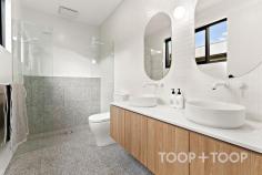 2F Egerton Ave Rostrevor SA 5073 Architecturally designed by the award winning Regent Homes, each fixture and fitting has been meticulously selected and is evident upon entering this stunning home constructed in 2023. Boasting a family sized floor-plan and sitting on an impressively sized block of 434sqm; there is plenty of room across both levels allowing privacy, space and flexibility for growing families. As you approach the front door via the stunning cantilever concrete steps and enter, you will instantly be in awe of the modern, crisp white and stone aesthetic complimented by stunning polished concrete floors. The four bedrooms are carpeted with built in wardrobes, and oversized windows eliminating the use for all day lighting. Enjoy the spacious main bedroom located on the ground floor showcasing a large walk-in robe and luxurious ensuite bathroom complete with terrazzo tiles imported from Italy, a dual-shower head, frameless shower screen and dual vanity. Transcend upstairs via the oak timber staircase into a large second living space fitted with easy clean engineered timber floors, perfect for a children’s retreat or extra guest entertaining space. The three bedrooms on this level share a gorgeous main bathroom complete with freestanding bathtub and a stunning tiling and fixture combination we are sure you'll love. The spacious downstairs living area incorporates a stunning oversized curved stone bench with plenty of room to prepare meals and entertain your guests. SMEG appliances set the bar high with style and functionality flowing through into the concealed butlers pantry which offers a built in bar, an abundance of storage along with a hidden sink and dishwasher. Avid entertainers will appreciate the undercover alfresco with built in gas line and outdoor fan. The spacious rear yard features a sparkling, electric heated swimming pool and large lawn to unwind with family and friends. Here's your opportunity to not only own an exceptionally crafted, custom-built home, but a chance to be part of a great community within this well loved location. Walk to Morialta Conservation Park on weekends, find your favourite coffee shop nearby and enjoy a selection of top-tier schooling options at your fingertips with Rostrevor College, Saint Ignatius College, Stradbroke Primary School and the brand new Morialta Secondary College just to name a few. Less than 5-minutes drive discover the well equipped Newton Shopping Centre or Firle Plaza, as well as the vibrant Parade in Norwood for shopping, café, specialty stores and weekend entertainment options. Added benefits include: *Family-sized electric heated swimming pool *Double car garaging *High fencing for privacy *Ducted and zoned, reverse cycle heating and cooling *2.7m ceiling heights *Semi commercial windows frames *Downstairs powder room with third toilet *Quality flooring throughout including polished concrete and imported terrazzo tiles *New sheer curtains *Separate downstairs laundry *Built in roof provisions for solar