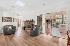 3 Cuneata Close Langwarrin VIC 3910 $880,000 - $925,000 Elegantly appointed, generously sized and curated for lifestyle lovers, this light filled Langwarrin oasis weds family friendly functionality with a host of high end upgrades across an alluring single level design. In a lovely residential estate just a short stroll to Langwarrin Park Primary School and The Gateway shopping mall, the four-bedroom residence sits amid tranquil gardens on an appealing 689m2 (approx) corner allotment. Having recently undergone a stunning modern makeover, the crisp and contemporary abode impresses with a choice of two spacious living areas, each opening to the alfresco, and a formal dining room. An exquisitely appointed cook's kitchen boasts stone benchtops, Asko dishwasher, Bosch induction cooktop, an oven and steam oven, while the woodgrain flooring, plush cream carpeting, light tones, lofty ceiling, exposed brick features and free flowing floorplan conspire to create fresh and inviting spaces. Dual sets of sliding glass doors open to the striking outdoor entertaining area between herringbone brick tiling and a high pitched pergola with a ceiling fan. Backdropped by a romantic outdoor fireplace, the terrace offers a European inspired elegance for exceptional open air hosting. Also spilling out to the garden, the master bedroom is fitted with a walk in robe and private ensuite, while the main bathroom indulges with a freestanding soaker tub, frameless glass shower and a marble vanity. With dual access on the corner block, the property provides both a double garage with a tradie's bathroom, along with an additional garage and caravan storage. Ducted heating, evaporative cooling, a wood heater and solar panels ensure all season comfort with affordability. Zoned for Elisabeth Murdoch College, the property is surrounded by parks, playgrounds, recreational facilities and public transport, around 3km to the freeway for easy commuting.