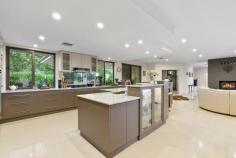 75 Bankers Road Bywong NSW 2621 Exquisitely designed and positioned to capture the northern sun, this grand family abode beckons those in search of perfection. With a secluded location, the expansive residence is ideal for large families, car enthusiasts (9 car garage!) or those seeking versatile living arrangements for extended family. Either way, 75 Bankers Road makes a powerful statement in style and sophistication with a heavy emphasis placed on indoor and outdoor entertaining and resort-style living. From the moment you step through the front door, your eyes are draw to the picturesque backdrop of the sparkling in-ground swimming pool and verdant grounds. A clever design encompasses formal and informal living areas, separate tv room and music/rumpus room, library and study. For the chef in the family there is the show stopping fully equipped entertainer's kitchen, complete with integrated Miele appliances and walk-in butler's pantry. It is the perfect place to cook up a storm and still be connected to family and friends. A segregated parent's retreat boasts a walk through robe, indulgent ensuite complete with spa bath and a private elevated terrace, the perfect spot to end the day. The secondary bedrooms offer a flexibility that is rarely found with a guest bedroom featuring its own ensuite, built-in robes to all rooms and the office/5th bedroom also with its own walk-in robe and ensuite access to a bathroom. Surrounded by beautifully landscaped gardens, you will find a prolific fruit tree orchard, vegetables gardens and manicured lawns spread across 1.18ha. Located in Hideaway Estate, you have exclusive access to an additional 37.12ha of community land, ideal for exploring on foot to find that perfect picnic spot, birdwatch or be one with the natural bush. Situated just over 18 minutes to Dickson, 7 minutes to Sutton Village and 14 minutes to Bungendore the commute is short. School buses depart from the entry to Bankers Road to Canberra's major schools, and Coles and Woolies home deliver giving you all the benefits of rural living without compromise. 75 Bankers Road is an outstanding example of rural living at its best with all of the hard work done. North facing solar passive home Expansive family residence on 1.18ha In slab electric heating to parents retreat and kitchen and family room Reverse cycle air-conditioning throughout Slow combustion fireplace in family room Double glazed argon filled windows Porcelain tiles in living area, spotted gum timber floors in entry and formal lounge dining An abundance of storage throughout Ducted vacuum Mudroom entries from garages Under house wine cellar 18m x 4m tiled lap pool with 2 separate lanes 20KW solar panels on roof 3 phase power Alarm system 100,000L water tank Bore water connected to garden taps 2 bore water community water tanks Manicured gardens around residence Orchard and vegetable gardens Formal gated entry to property - with beautifully designed Corten inserts Council Rates: $1,648pa (approx.) Community Fees: $1,800pa (approx.)