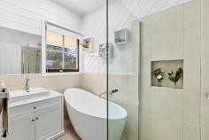 3 Cuneata Close Langwarrin VIC 3910 $880,000 - $925,000 Elegantly appointed, generously sized and curated for lifestyle lovers, this light filled Langwarrin oasis weds family friendly functionality with a host of high end upgrades across an alluring single level design. In a lovely residential estate just a short stroll to Langwarrin Park Primary School and The Gateway shopping mall, the four-bedroom residence sits amid tranquil gardens on an appealing 689m2 (approx) corner allotment. Having recently undergone a stunning modern makeover, the crisp and contemporary abode impresses with a choice of two spacious living areas, each opening to the alfresco, and a formal dining room. An exquisitely appointed cook's kitchen boasts stone benchtops, Asko dishwasher, Bosch induction cooktop, an oven and steam oven, while the woodgrain flooring, plush cream carpeting, light tones, lofty ceiling, exposed brick features and free flowing floorplan conspire to create fresh and inviting spaces. Dual sets of sliding glass doors open to the striking outdoor entertaining area between herringbone brick tiling and a high pitched pergola with a ceiling fan. Backdropped by a romantic outdoor fireplace, the terrace offers a European inspired elegance for exceptional open air hosting. Also spilling out to the garden, the master bedroom is fitted with a walk in robe and private ensuite, while the main bathroom indulges with a freestanding soaker tub, frameless glass shower and a marble vanity. With dual access on the corner block, the property provides both a double garage with a tradie's bathroom, along with an additional garage and caravan storage. Ducted heating, evaporative cooling, a wood heater and solar panels ensure all season comfort with affordability. Zoned for Elisabeth Murdoch College, the property is surrounded by parks, playgrounds, recreational facilities and public transport, around 3km to the freeway for easy commuting.