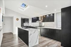 26 Koombala Grove Cordeaux Heights NSW 2526 $1,300,000 Built to make lasting memories, this 'happily ever after' family home will impress and inspire in equal measure. Providing a haven of comfort, this serene sanctuary features five generously proportioned bedrooms with built-in wardrobes, a tastefully renovated main bathroom with a strategically positioned skylight that allows natural light to shine through, a split-level entertaining area you'll gravitate to year-round and a bar that will surely be your go-to date night spot. The modern kitchen caters to culinary enthusiasts with its gas cooktop, ample bench space and a walk-in pantry where your organisational skills can truly shine. You'll need to see this property to appreciate its full potential with an impressive floor plan that maximises liveability, high ceilings, a cosy fireplace for added charm and warmth and a leafy outlook with escarpment views. Features - Tastefully renovated six bedroom family home plus a study - High ceilings, fireplace, leafy outlook, bar area - Main bedroom with balcony, ensuite with spa - Study to suit students or WFH professionals - Modern main bathroom with skylight feature, tub
