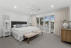42 Henderson St Bulimba QLD 4171 Boasting stunning city views and a luxurious swimming pool, this five-bedroom property built in 2020 by Evermore+ is a testament to high-end design and superb attention to detail. Just a stone’s throw from Oxford Street’s popular cafes, restaurants and boutiques, this dual-level residence also features brilliant entertainment options, elegant interiors and intelligent layout. Showcasing luxurious finishes and an exquisite Hamptons-inspired aesthetic, the home exudes timeless refinement with a grand character facade, an elevated aspect and established front gardens. Equally beautiful, the property’s interiors benefit from timber and carpeted floors. Plantation shutters and a crisp white colour palette also come together to create an attractive setting. Serving as a fantastic place of gathering, a spacious open-plan living and dining area on the ground level is accented by integrated joinery and a dedicated study nook. Perfect for hosting an unforgettable celebration or preparing a delicious meal at home, a sensational adjoining kitchen displays a breakfast bar, a butler’s pantry, Miele appliances and ample cupboard storage. You will also find a versatile multi-purpose or media room, plus a covered al fresco area encompassing a full outdoor kitchen with a built-in barbecue and a wine fridge. Extending from here is a fully-fenced grassed rear yard with landscaped gardens, as well as a heated in-ground swimming pool and an attached terrace. Finishing the ground level is a full bathroom, while a study and a rumpus room/fifth bedroom are upstairs. Connecting to a private balcony commanding breathtaking city views, an ensuited master bedroom also has a walk-in robe. Three additional bedrooms featuring built-in robes are serviced by a well-appointed main bathroom, which boasts a separate bath and shower. Complete with a secure dual garage and an internal laundry/mudroom, the property also includes ducted air-conditioning, ceiling fans, marvellous storage and a 13.2-kilowatt solar power system with a Goodwe inverter. Only a leisurely stroll from the Bulimba Ferry Terminal and scenic riverwalks, this exceptional residence is near Bulimba Memorial Grounds’ sporting facilities. Bulimba Riverside Park’s playgrounds, Hawthorne Road’s attractions and numerous city-bound bus stops are minutes away. Falling within the Bulimba State School and Balmoral State High School catchment areas, this outstanding home is also a short distance from Saints Peter and Paul’s School, Lourdes Hill College and Anglican Church Grammar School.