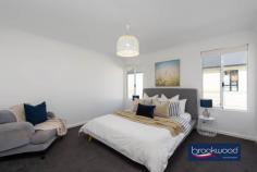 4 Beresford Gardens Swan View WA 6056 $1,100,000 Step into a life where family, convenience, and the joy of outdoor living meet in perfect harmony. Open the door to home that makes the daily to-and-fro of family life a little easier and brings the added joy of extended family mere seconds away. This centrally situated family home and two-bedroom ancillary accommodation are steps from a bus stop, minutes from local primary and secondary schools, and ideally located to enjoy the great outdoors while exploring the Heritage Trail and John Forest National Park. 4 bedrooms 2 bathrooms 2022-built Hardi and c/bond Indoor-outdoor floorplan Impeccable presentation Decked front verandah Dbl 2.4m-clearance garage 2 x 1 ancillary accomm Space to build a workshop 1296 sqm fenced block Incredible walkability Turnkey ready with the style turned up to ten, this as-new home boasts fresh, contemporary interiors, modern open-plan living, and a floor plan designed for an indoor-outdoor lifestyle. The principal house sits towards the front of a generous lot, behind a white fence and a neat-as-a-pin yard. Beyond the white fence and front yard, the green playing fields of Brown Reserve create the impression of an acreage estate without the upkeep. At the core of the main home’s thoughtful design is an expansive open-plan living space that flows effortlessly onto a decked alfresco area, perfect for seamless indoor-outdoor living. A wall of north-facing windows, dressed in elegant plantation shutters and a sliding glass door, invites abundant natural light into the heart of the home. The refined interior palette combines crisp white tones and warm greys, punctuated by bold black accents, creating a sophisticated yet inviting atmosphere that defines modern living. At one end of the open-plan layout lies a sleek, well-appointed kitchen featuring stone benchtops and an island with an integrated breakfast bar. Thoughtfully designed with overhead cabinets, ample under-bench storage, an electric oven, a 5-burner gas hob, and a dishwasher, this space is perfect for those who enjoy cooking and entertaining. The adjoining dining area and generously proportioned family room create a warm, sociable space for gathering with friends and family in relaxed, contemporary comfort. The home boasts zoned, ducted reverse-cycle air conditioning. A pair of barn-hung doors lead from the open plan, one to a utility room comprising a walk-in pantry and a walk-through laundry and the other to the bedroom wing. The main bedroom is accessed via a central hallway and offers a generous retreat. It features plush carpeting, a walk-in wardrobe, and a refined ensuite with double vanity, a spacious shower, a WC, and striking black tapware. The patterned floor tiles echo the home’s cohesive palette, extending into the family bathroom, which mirrors the sleek styling of the ensuite. Further along the hall, tucked in a small alcove, a shoppers’ entry opens to a two-car garage with a 2.4-metre clearance and an automatic door. The junior wing, positioned at the rear of the home, comprises three well-proportioned bedrooms, each with built-in robes and soft carpeting. Designed for versatility, these spaces are ready to adapt to the needs of growing children, with a neutral palette awaiting the personal touches of family life. The paved driveway continues past the main home towards the rear of the L-shaped lot to an open space suitable for building a workshop on one side and a two-bedroom, one-bathroom granny flat on the other. Elevated behind a lush hedge and a north-facing patio, the granny flat is accessed through a formal entry that sets a welcoming tone. Timber look flooring flows throughout, while large north-facing windows and a sliding glass door invite abundant natural light into the open-plan living area. Reverse cycle air conditioning ensures comfort year-round. The spacious kitchen is thoughtfully designed with open shelving, under-bench cabinets, and an L-shaped benchtop, complemented by a peninsula breakfast bar. An electric wall oven and cooktop complete the sleek, functional space. The main bedroom, positioned at the front of the home, enjoys the light from north-facing windows, timber look flooring, and a large built-in robe. A second well-proportioned bedroom also features timber look floors. The shared bathroom is practical and stylish, offering a large walk-in shower, vanity, WC, and cleverly integrated laundry space. This property offers modern, open -plan living, perfect for family life and entertaining. Ideally positioned, it combines the convenience of being steps from local schools and amenities with access to the green spaces of Brown Reserve and nearby outdoor pursuits like the Heritage Trail and John Forest National Park. The principal residence features sophisticated interiors and a seamless indoor-outdoor flow, while a separate two-bedroom unit offers flexible accommodation for multi-generational living or guest stays. With space for a potential workshop, this property offers luxury and versatility without compromise.