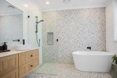 45 Sunninghill Circuit Mount Ousley NSW 2519 Set on a generous 670 sqm block in the highly sought-after suburb of Mount Ousley, this five-bedroom home is tailor-made for modern family living. Reflecting a strong commitment to form and function, it boasts a complete renovation with a generously sized dual-level design featuring a main bedroom with an ensuite and walk-in-wardrobe, an all-seasons entertainers deck and a charming sun-drenched backyard surrounded by mature greenery, offering a sense of privacy that's become increasingly rare in today's suburban landscape. At the heart of this home lies a modern kitchen, complete with a 900mm gas cooktop, sleek skylight, spacious island, stone bench tops and ample storage, sure to make meal time a breeze. Designed with versatility in mind, the ground floor is a flexible space that can adapt to your family's evolving needs. Whether it's guest quarters, a teenage retreat, or even a home business, this area-with its own kitchenette, bedroom, bathroom, and study-offers endless possibilities. Positioned within the catchment area to the exclusive Pleasant Heights Public School and just minutes to the Fairy Meadow shopping district and Balgownie's charming Village, this is more than just a house; it's where your family's story begins. Features: Ducted air conditioning throughout, plantation shutters, engineered floorboards Open plan living, recently renovated, double garage with internal access Main bedroom with walk-in-wardrobe and ensuite with double basin + bath Private backyard with lush greenery, side access, ideal for kids and pets Oversized undercover deck ideal for year round entertaining