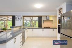 33 Whitehall Rd Hazelmere WA 6055 $1,400,000 This stunning 3.2-acre property offers a dream country lifestyle just 16km from Perth CBD. Highlights include various sheds and an awesome workshop, a large fenced paddock, multiple outdoor entertaining areas, and lush gardens. With a welcoming entrance and numerous features, it’s hard to know where to start. The light-filled home features open-plan living and a formal lounge/dining area. The master bedroom, with bay window, offers stunning garden views, a walk-in robe, and a spacious en-suite. The formal lounge and dining area lead to a renovated kitchen with designer appliances and a shopper’s entry from the double carport. The family room and meals area, warmed by a wood fire, overlook the kitchen. Three king-sized bedrooms with built-in robes are located down the hallway, alongside a bathroom and laundry. The highlight of this rare property is the usable 3.2 acres. Fed from a plentiful bore, the land surrounding the home can stay green all year round. You will definitely need a ride on mower to keep the parkland gardens looking their best. Subject to approval, you could have a horse, park a truck, run a business or you could simply enjoy the privacy that this acreage property provides. Enjoy outdoor gatherings under the wrap-around patio, with views of the expansive lawn and fenced paddock. The property includes a 100sqm powered workshop with a mezzanine and hoist, plus a large shed with double roller doors. Features include: Fully fenced with double front gates Massive workshop with 4T car hoist Circular driveway, double carport and shed Lush lawns and tropical gardens Undercover parking for caravans or boats Wrap-around entertaining and large gabled patio Spacious master bedroom with bay window Modern kitchen with breakfast bar Open-plan family and meals areas with wood fire Ducted air conditioning, solar panels Just a short drive to Midland Shopping Precinct and 10 minutes to Perth Airport, this home offers a blend of country charm and city convenience.