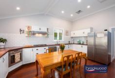 5 Stuart St Greenmount WA 6056 $739,000 Write your own story of home and family in this storybook cottage, blending modern comfort with timeless charm. A fragrant garden offers a welcoming embrace. Polished jarrah floors, high ceilings and intricate cornices lend a sense of timeless elegance and smart-wired air; reticulation and lighting bring contemporary convenience. Every detail has been carefully considered, from the cleverly expanded primary suite to the family room that flows effortlessly into the kitchen and outdoor spaces. 3 bedrooms 2 bathrooms 1930-built weatherboard Polished jarrah floorboards High ceilings & dec cornices Smart wired air, retic, lights Country-style eat-in kitchen Flexible sunroom/playroom Brick paved rear verandah 655 sqm fully fenced block Walk Heritage Trail & NP A white picket fence and perfumed garden, where lavender and roses grow, offer a charming invitation to this storybook cottage that effortlessly blends modern features with traces of authentic heritage. The home is accessed via a leadlight door that opens onto polished jarrah floors, setting the tone for the home’s cohesive interior of soft greys and whites, complemented by high ceilings and intricate cornices. At the front of the home, a thoughtfully updated traditional layout features a central hallway flanked by bedrooms. The primary suite was cleverly extended by enclosing a side verandah, creating a light-filled haven with a fitted walk-in robe and ensuite. This peaceful space is anchored by a decorative open fireplace and a trio of timber-framed windows, while elegant leadlight sliding doors artfully conceal the ensuite and robe. Continuing along the central hall, the rear of the home exemplifies the seamless balance between modern amenities and period charm. The family room boasts high ceilings and polished floorboards, a second decorative fireplace and a wide casement window connecting to a versatile sunroom or playroom. The eat-in kitchen, a blend of traditional character and contemporary design, features an expansive timber benchtop, an electric oven, a 5-burner hob and a dishwasher, with plenty of storage options, including white cabinetry and open shelving. Bathed in natural light, this well-proportioned kitchen offers views of the garden. The east-facing sunroom/playroom leads to the third bedroom, which has split-system air conditioning. A shared family bathroom with an over tub shower, a vanity and a WC is centrally located at the end of the hallway. The home is smart-wired for convenience, with reverse-cycle ducted air, reticulation and lighting systems accessible via an app. French doors open from the sunroom to a brick-paved verandah, providing an idyllic space for year-round outdoor living and entertaining, with ample room for both dining and lounging. You’ll find a functional laundry with storage and workspace at one end of the verandah. The garden offers a picturesque setting, with a central lawn, established boundary plantings, a mature shade tree and space for children and pets to enjoy. A small garden shed sits neatly at the rear, framed by a vibrant bougainvillea, while the brick-paved driveway comfortably accommodates parking for three cars and provides gated access to the backyard. Stuart Street offers a foothills location with easy access to Midland and beyond, steps from hours of walking and riding along the Heritage Trail and within easy reach of John Forrest National Park. Numerous State and private schools are nearby, and public transport, arterial road links and the airport are all minutes from the front door of this beautifully presented, utterly charming home.