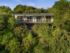20 Ennisvale Ave Sandy Point VIC 3959 $800,000 Sitting proudly on a gently sloping block of approx. 654m2, this much loved beach house is filled with natural light and takes in views over the township to Shallow Inlet and the distant hinterland. The open plan living room is comfortable year-round with RC/AC and doors to the deck that can be opened to catch the breeze in the warm months. Kitchen with breakfast bar to meals area. Three bedrooms, central bathroom, separate w.c. and laundry. Well maintained, the property has recently been re-painted and the roof and insulation replaced. Hardwood flooring is in place under the existing carpet. Low maintenance block with a fringe of native vegetation to attract birds and wildlife. A flat section near the road houses a large LU garage / workshop / boat shed and enables parking multiple cars. Bore and tank water. Being sold furnished and ready for a new owner to make happy memories.