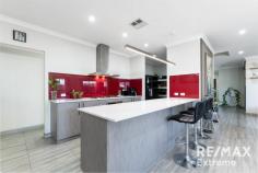 14 Manila Rd Clarkson WA 6030 This beautiful 4 bedroom 2 bathroom home is set in the heart of the exclusive Catalina Estate and offers executive style living throughout. Set on a low maintenance 450 sq/m block yet offering 236 sq/m of living space, this well designed Ben Trager home has it all. Perfectly located in a ultra quiet street, it has easy access to transport, schools, parks and all the shops that Ocean Keys has to offer. The timber door welcomes you and the high ceilings impress you as you enter the home. The large theater room, with built in projector and speakers, is plenty large enough for all your friends and family to enjoy. There’s a good size study, with multiple desk spaces, to allow an easy working from home set up. The open plan lounge/family/dining area benefits for feature wall decorations and lighting, T.V. point, plenty of light from those large windows, lovely window treatments and the impressive tiled floor coverings which add a touch of luxury to this area. This open plan area is overlooked by the chef’s delight kitchen. It has plenty of workbench space, breakfast bar, lots of cupboard storage, coloured splash back, separate oven and burners, feature lighting and views towards the rear garden, just perfect when entertaining. There is an extended Butler’s Pantry with double sinks, water filter, large fridge recess, dishwasher, power points, and even more built in storage for the budding chef in the household. The three family bedrooms are on their own wing of the property. Each has built in robes, great amount of space, plenty of light from the large windows and an element of separation/privacy from the rest of the family. They are serviced by a family bathroom with shower and bath, vanity unit and a hotel style. The laundry and toilet finish off this section of the property. Passing the under stairs storage, you utilise the staircase to enter the upstairs parent’s retreat. This space is perfectly designed for your private time with T.V. point, power sockets for the fridge, tea and coffee making facilities, and room for an ample sofa to relax upon. The master bedroom has great views over the suburb and benefits from a good size walk in robe and plenty of space for additional furniture. The ensuite is again hotel style, with large double headed shower, heat lights to ceiling, feature lighting above the large mirror, double vanity unit and separate toilet. The outside rear garden is accessed by sliding doors from the dining area. The deck offers all year entertaining under the roof of the property. The low maintenance artificial lawn is plenty large enough for the children and pets to enjoy. Not overlooked, it offers great views and privacy, you could even add a swimming pool if that’s your future requirement. Extras include – Ducted reverse cycle zoned air conditioning 5.5 kw solar electricity generation Security cameras and doorbell camera 3 phase power Extended store area to garage