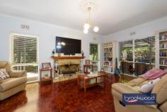 11 Hawkstone Street Gidgegannup WA 6083 $1,200,000 A gently graded landscape rolls from the road to a hidden glen and quality-built family home surrounded by ample outdoor living and entertaining space. The home boasts a flowing floorplan, formal and informal living and dining high ceilings and a bright neutral palette. 4 bedrooms 2 bathrooms 1990-built brick and iron High ceilings throughout Open plan & formal living Multi outdoor entertaining Principal suite private patio Separate jnr bedroom wing Powered studio & workshop 5-acres with high-yield bore Hideaway with convenience A wide stone staircase leads to the home’s front door and formal entry, but the south-facing door into the open-plan living zone most often welcomes friends and family. This casual, friendly welcome sets the tone for a relaxed, family-focused lifestyle. Approached via a wide stone staircase, the home’s formal entry has a sense of grandeur and sophistication. Yet, the backdoor – opening from a south-facing patio embodies the true spirit of this welcoming residence. Step inside via this ‘friends’ entrance, and the luminous style of the open-plan kitchen, meals, and family room immediately embraces you. Parquet floors run underfoot, and large windows to the north and south fill the room with natural light and garden views. A slow-combustion fireplace casts a cosy glow, and split-system air conditioning ensures year-round comfort. High ceilings emphasise the volume and ease of the flowing floorplan, setting the stage for a relaxed, family-oriented lifestyle. A thoughtfully designed kitchen beckons with its stone-topped island and breakfast bar– ideal for morning coffee or casual meals. Surrounding the electric oven and cooktop, an L-shaped benchtop provides ample workspace, while a dishwasher, extensive cabinetry, and a large walk-in pantry keep the space pristine and organised. The formal living and dining rooms extend from the main entry. Here, polished parquet floors gleam in the light of an open fireplace, creating an atmosphere of warmth and refinement. Adjoining the lounge, the formal dining room connects to the south-facing patio, perfect for alfresco dining or evenings spent entertaining. From the open-plan hub, a private junior wing offers a quiet retreat. Three well-appointed bedrooms – two with carpets and built-in robes, one with parquet flooring – provide a flexible backdrop for the tastes and needs of kids of all ages. Featuring a claw-foot bathtub, the family bathroom has a measure of old-fashioned charm. A walk-through laundry with abundant storage and a separate WC complete the layout in the junior wing. Picture yourself waking up in a serene primary suite, where French doors open to a verandah draped with wisteria. This is your private haven, complete with plush carpeting, a split-system air conditioning unit, and a spacious walk-through robe leading to an ensuite featuring a double vanity, a shower, and a WC. Set on a 5-acre lot, this home is a sanctuary of privacy and possibility. Imagine strolling through arbours, enjoying the changing seasons in the gardens, or retreating to the powered brick studio for creative pursuits. A powered workshop provides ample space for projects or hobbies. The property is as functional as it is beautiful, with a productive bore and filtration system supplementing generous rainwater tanks, a choice of nearby schools including Mundaring Christian College, Parkerville Primary School, Parkerville Steiner School and Silver Tree Steiner School along with school pickup on Roland Road. The nearby Parkerville Tavern is a family-friendly local, and the Gidgegannup township boasts a much-loved bakery, local doctors, a chemist, and fuel. Midland and Mundaring, with their extensive services and amenities, are both an easy drive away. Whether you’re seeking space for work, play, or to unwind, this property delivers on every level. Designed for modern living with a home filled with peace and tranquillity. Welcome home.