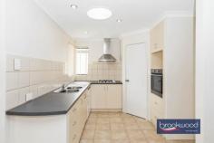 Unit 4/3 George St Midland WA 6056 $499,000 Nestled behind a secure gate, this rear villa exudes warmth and charm, offering an open-plan layout with distinct lounge and dining areas, 3 spacious bedrooms, 2 modern bathrooms, and a private paved courtyard complemented by a gabled patio. Brick & tile villa built 2003 3 bedrooms, 2 bathrooms Spacious 130 sqm villa Rear positioning Reverse cycle air conditioning Secured gated complex Single garage w roller door Paved courtyard with patio Privately managed strata Well balanced for easy living Upon entry, you’re greeted by a small entrance space that leads to a tiled, open area seamlessly connecting the living room, dining area and kitchen. The space is bright and airy, enhanced by natural light streaming through the dual sliding glass doors. The distinct separation between the lounge and dining areas enhances the sense of space and dimension. The kitchen features an L-shaped bench design with ample cabinetry, a pantry, gas and electric cooking options and space for a fridge. It also boasts the convenience of a dishwasher, making it both functional and stylish. Windows at the front of the unit allow plenty of natural light and provide a pleasant view. Down the upgraded, well-lit hallway are three bedrooms – each equipped with built-in robes and split system air conditioners for year-round comfort. The generous master bedroom includes an oversized built-in robe with mirrored doors and an ensuite with a vanity, shower and toilet, creating a fresh and spacious retreat. The main bathroom caters to the whole family, offering a shower, a separate bathtub and a separate toilet. The functional laundry area is conveniently tucked off the hallway, with a sliding glass door leading to the rear courtyard for easy access. The outdoor space is simple yet versatile, with the majority – paved. It offers future gardening possibilities for green-thumb enthusiasts. The private courtyard, accessible via a side gate, is perfect for entertaining under the gabled patio, with dual sliding glass doors connecting the outdoor and indoor spaces. An additional side area serves as a practical utility space, ideal for storage or drying laundry. The single car garage features an automatic roller door and internal shoppers’ access, ensuring convenience regardless of the weather. There’s also an internal storage room inside the garage accessible from the courtyard, providing ample storage options. Currently tenanted until March 2025, this villa appeals to both investors and home seekers, with a reliable tenant in place and a privately managed strata between owners. It presents a fantastic investment opportunity with the flexibility to nest in the future.