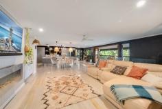 32 Kerenjon Avenue Buderim QLD 4556 Experience this exceptional family retreat, where modern living merges with timeless coastal charm. Nestled on a generous 1,186m² allotment, this home boasts sweeping northeastern views and a harmonious blend of style and warmth. This expansive three-level home is ideal for large families or those seeking a genuine dual-living setup. The lower level features three bedrooms, a central living and dining area, a kitchenette, and a bathroom, all thoughtfully finished in calming coastal tones. With complete, private living quarters, this space is perfect for an Airbnb rental or extended family, offering an excellent opportunity to support mortgage repayments. Ascend the staircase or follow the landscaped side path to reach the main level, where beautifully painted and polished hardwood floors welcome you into a spacious, open-plan living area. Here, the lounge and dining spaces are perfectly positioned to capture breathtaking hinterland and ocean views. The lounge is thoughtfully designed with custom built-in cabinetry, ample storage, an electric fireplace for cosy evenings, and split-system air conditioning for year-round comfort. The chef's kitchen is a true centrepiece, showcasing high-end stone and marble finishes for a luxurious touch. Fully equipped for culinary endeavours, it includes a built-in grill, deep fryer, five-burner induction cooktop, Fisher & Paykel dishwasher, soft-close drawers, ample cabinetry, and a breakfast bar that offers beautiful ocean views as you enjoy your morning coffee. From the main living area, timber stacker doors open to an expansive deck, ideal for year-round entertaining and the perfect spot to celebrate the upcoming holiday season. The top level offers a private retreat featuring an additional bedroom, a stylish bathroom with patterned tiles, a timber vanity, and a stone basin, along with a versatile storage or multi-purpose room. Here, the master suite awaits - the perfect escape with a spacious ensuite complete with double vanities, elegant 600mm tiles, a freestanding bath and shower, a generous walk-in robe, a separate toilet, and split-system air conditioning for ultimate comfort. Additional features include a three-car carport for vehicles and equipment, a timber viewing deck adjacent to the carport, and extensive under-house storage. Situated in the sought-after northern Buderim precinct, you'll enjoy quick access to major amenities, with the local Coles shopping village just a short stroll away, Buderim Village five minutes by car, and bustling Maroochydore within a 10-minute drive.