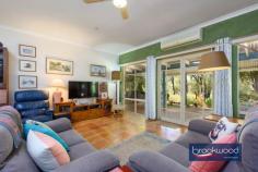 9 Clipson Cres Mundaring WA 6073 $899,000 Hidden behind a lush, vibrant front garden, this home is a true sanctuary in the serene, glen-like setting of the prestigious Noblewood Estate. From the moment you arrive, the home invites you in with its timeless charm and thoughtful design. With schools, parks, the bridle trail and Mundaring Village all within easy reach, it is perfect for families who value comfort, convenience, and a connection to nature. 4 bedrooms 2 bathrooms 2000-built brick and iron Central open-plan living Indoor-outdoor floorplan Elevated alfresco entertain RC air con & ceiling fans Drive-in gated rear access Tandem carport storeroom Landscaped 2001 sqm lot Walk to school and park Designed to celebrate light, space, and the inimitable beauty of the Perth Hills, this delightful home offers a wide south-facing verandah, a perfect perch to watch birds flit and play in the front garden, and a deep, sheltered patio, an elevated site for relaxing and entertaining against a backdrop of majestic gums standing sentinel at the property’s rear boundary. Large windows across the rear of the home invite a beautiful quality of natural light into the interior spaces. To one side of the tiled entrance, a well-considered layout unfolds, featuring a convenient guest powder room, a cozy minor bedroom, and the principal suite, providing a peaceful retreat with plenty of space for relaxation. At the heart of the home lies the open-plan kitchen, meals area, and family room, a bright and inviting space designed to bring loved ones together. Natural light floods the area, accentuating its spaciousness and warmth. Every season is a delight, with reverse-cycle air and a ceiling fan. One corner of this open plan features a kitchen equipped for culinary creations. Anchored by a stone-topped bench and integrated breakfast bar, it is a cook’s delight. A walk-in pantry and cabinetry in a soft cream finish provide ample storage and ensure everything has its place. Meal prep is a breeze, thanks to an electric oven, gas hob, and dishwasher that make clean-up effortless. Comfort, elegance, and considered design converge to create a haven for every family member. This property is tailored to meet the demands of modern living with an ideal balance of privacy and shared spaces. The principal bedroom is a blissful retreat at the rear of the plan. North-facing windows flood the space with filtered light, offering a serene start to each day with breathtaking views of the surrounding landscape. This sanctuary, humming with an air of comfort and calm, is complemented by a private ensuite and a spacious walk-in wardrobe. The design effortlessly accommodates family life with a junior wing that extends from the central living area – comprising two carpeted bedrooms with built-in robes, a well-appointed family bathroom, and a convenient walk-through laundry. The third junior bedroom is currently styled as a home office and would make an ideal guest room or nursery for a young child. A large walk-in linen press adds extra practicality, ensuring every corner of this home is as functional as stylish. Step out onto the north-facing verandah, where you’ll find an ideal spot to entertain, dine alfresco, or bask in the tranquil ambience of your private oasis. For those who love to entertain, the large paved and covered outdoor space offers an inviting area to gather with friends and family. Whether it’s a casual weekend barbecue or a more formal soirée, this elevated space, looking across gardens to a landscape dotted with eucalypts and grass trees, will make outdoor entertaining a joy, no matter the occasion. With every element referencing the stunning Hills setting – luminous interiors, seamless indoor-outdoor connections and relaxed style – this home is designed to elevate everyday living while maintaining a sense of connection and harmony.