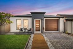 59 Press Rd Brooklyn Park SA 5032 $830,000 to $850,000 Perfectly placed along the tree-lined Press Road an easy stroll from Lyons Street Reserve and local favourite Karma and Crow café, this contemporary Fairmont Homes courtyard is ready for its second owner. Framed behind an attractive slatted timber fence with electric gate, a front lawn area is safe and secure for little legs, before a tiled entry hall welcomes you inside. Three bedrooms are easily accessible, including a master suite with walk-in robe and roomy ensuite bathroom with huge shower, while bedrooms two and three each enjoy built-in robes and are serviced by a central family bathroom with inset bath, shower and convenient separate w/c. An open plan living and dining space at the rear is overlooked by a supremely functional kitchen where home cooks will be most comfortable, complete with full-height cabinetry, island bench with breakfast bar, gas cooktop, dishwasher and corner pantry. Bright northerly aspect sliding doors open onto a tranquil rear yard that brings the holidays to you with a raised corner deck with Balinese-style hut and gardens. An invaluable casual second living area off of the hallway enjoys its own sliding door access to a huge side deck with pitched roof pergola; the prime spot for BBQ's and outdoor dining. The finer points: - Ducted reverse cycle air conditioning - Feature wall with gas heater to living - LED lighting throughout - Extra roomy oversized single garage with roller door access - Recently installed solar panel system - Torrens Titled 384sqm (approx.) allotment - Quality 2012-built by Fairmont Homes A stone's throw from the myriads of popular restaurants and eateries lining Henley Beach Road and the Torrensville area, and only 5 minutes from the sea or CBD, the possibilities are endless when it comes to nice evenings dining out. With Adelaide Airport and transport at your fingertips, local schools, the Kooyonga Golf Club and shops just minutes away, there's plenty to love about the location.