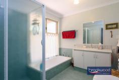 9 Clipson Cres Mundaring WA 6073 $899,000 Hidden behind a lush, vibrant front garden, this home is a true sanctuary in the serene, glen-like setting of the prestigious Noblewood Estate. From the moment you arrive, the home invites you in with its timeless charm and thoughtful design. With schools, parks, the bridle trail and Mundaring Village all within easy reach, it is perfect for families who value comfort, convenience, and a connection to nature. 4 bedrooms 2 bathrooms 2000-built brick and iron Central open-plan living Indoor-outdoor floorplan Elevated alfresco entertain RC air con & ceiling fans Drive-in gated rear access Tandem carport storeroom Landscaped 2001 sqm lot Walk to school and park Designed to celebrate light, space, and the inimitable beauty of the Perth Hills, this delightful home offers a wide south-facing verandah, a perfect perch to watch birds flit and play in the front garden, and a deep, sheltered patio, an elevated site for relaxing and entertaining against a backdrop of majestic gums standing sentinel at the property’s rear boundary. Large windows across the rear of the home invite a beautiful quality of natural light into the interior spaces. To one side of the tiled entrance, a well-considered layout unfolds, featuring a convenient guest powder room, a cozy minor bedroom, and the principal suite, providing a peaceful retreat with plenty of space for relaxation. At the heart of the home lies the open-plan kitchen, meals area, and family room, a bright and inviting space designed to bring loved ones together. Natural light floods the area, accentuating its spaciousness and warmth. Every season is a delight, with reverse-cycle air and a ceiling fan. One corner of this open plan features a kitchen equipped for culinary creations. Anchored by a stone-topped bench and integrated breakfast bar, it is a cook’s delight. A walk-in pantry and cabinetry in a soft cream finish provide ample storage and ensure everything has its place. Meal prep is a breeze, thanks to an electric oven, gas hob, and dishwasher that make clean-up effortless. Comfort, elegance, and considered design converge to create a haven for every family member. This property is tailored to meet the demands of modern living with an ideal balance of privacy and shared spaces. The principal bedroom is a blissful retreat at the rear of the plan. North-facing windows flood the space with filtered light, offering a serene start to each day with breathtaking views of the surrounding landscape. This sanctuary, humming with an air of comfort and calm, is complemented by a private ensuite and a spacious walk-in wardrobe. The design effortlessly accommodates family life with a junior wing that extends from the central living area – comprising two carpeted bedrooms with built-in robes, a well-appointed family bathroom, and a convenient walk-through laundry. The third junior bedroom is currently styled as a home office and would make an ideal guest room or nursery for a young child. A large walk-in linen press adds extra practicality, ensuring every corner of this home is as functional as stylish. Step out onto the north-facing verandah, where you’ll find an ideal spot to entertain, dine alfresco, or bask in the tranquil ambience of your private oasis. For those who love to entertain, the large paved and covered outdoor space offers an inviting area to gather with friends and family. Whether it’s a casual weekend barbecue or a more formal soirée, this elevated space, looking across gardens to a landscape dotted with eucalypts and grass trees, will make outdoor entertaining a joy, no matter the occasion. With every element referencing the stunning Hills setting – luminous interiors, seamless indoor-outdoor connections and relaxed style – this home is designed to elevate everyday living while maintaining a sense of connection and harmony.