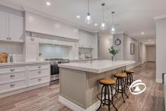 15 Axnick Rise Officer VIC 3809 $1,180,000 - $1,280,000 Elegant. Luxurious. Unforgettable. No stone has been left unturned in crafting this breathtaking family home, from its commanding street presence to the impressive backyard retreat. Perched on a generous 700sqm (approx.) allotment, this one-of-a-kind residence offers a thoughtfully designed floor plan that blends elegance with functionality. Step inside, and you'll immediately be captivated by soaring ceilings and a wide, inviting hallway that sets the stage for the sophistication within. A formal living room provides a peaceful space to unwind before moving into the heart of the home—a stunning open-plan kitchen, dining, and family zone. The kitchen is an entertainer’s dream, featuring premium stone benchtops, soft-close drawers, a tiled splashback, top-tier appliances, and an enormous butler’s pantry. Smart storage solutions include a walk-in linen cupboard with a hidden storage area, perfect for a cellar or extra pantry space. Four spacious bedrooms provide built-in robes, with the primary suite offering a private retreat complete with a luxurious ensuite featuring a double vanity and a walk-through wardrobe. The family bathroom mirrors the same attention to detail, highlighted by a sleek freestanding bath. Multiple living spaces offer versatility for every occasion, including an upstairs retreat with panoramic views, a study nook, and electric skylights that enhance natural light throughout the day. The oversized garage is equally impressive, with soaring ceilings, additional storage under the stairs, and internal access. Side access adds practicality, with ample space for a caravan, boat, or trailer. Outdoors, an expansive deck creates the perfect setting for alfresco dining and entertaining while enjoying breathtaking views. Perfectly positioned on the hilltop opposite Hicks Reserve, this home is just moments from parks, cafés, schools, public transport, and the M1. Built by renowned builder Smarthomes and featuring an array of premium upgrades, this property delivers the ultimate lifestyle package. Inspect today to experience it for yourself!