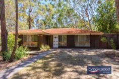 61 Hartung St Mundaring WA 6073 $769,000 A prime location opposite Harry Riseborough Reserve makes this home a walker’s paradise, with parks, trails, schools and shops all nearby. Set on a generous block, the property features light-filled interiors, ample space for alfresco entertaining and a versatile workshop complete with a lean-to and drive-in access. This is an exceptional opportunity to embrace Hills living at its finest, providing the ideal foundation for a relaxed and connected lifestyle. 3 bedrooms 1 bathroom 1972-built brick and tile South-facing family room Updated kitchen/meals Light neutral interiors 6m x 6m shed and lean-to Side access & in-out drive Reverse cycle air-con 1796 sqm lot opp reserve Walk village school sport Set well back from the road, behind an in-out driveway, this Mundaring home presents a welcoming face to the world. The front door opens to reveal a light and cohesive palette of colours and materials. Modern interventions blend seamlessly with original elements in luminous and practical interiors. Timber windowsills and door frames sit comfortably with a muted-toned carpet and practical timber-look vinyl floor in high-traffic areas; sliding doors maximise space and enhance the flow of the layout. At the front of the plan, a family room boasts a large, south-facing window looking onto the natural landscape of the front yard. Reverse cycle air conditioning ensures this central living zone is comfortable throughout the year. This inviting space can be styled as a lounge and dining room, offering flexibility for relaxing or entertaining. Alternatively, the kitchen is generously sized and comfortably accommodates a table. A timeless monochrome palette defines a sleek and modern kitchen. White cabinetry is complemented by striking black benchtops and a tiled splashback, creating a clean and contemporary aesthetic. The stainless-steel finishes of the freestanding electric oven, dishwasher and rangehood add a polished touch, while black hardware on the overhead and under-bench cabinets ties the design together. A white sink provides a crisp contrast, enhancing the overall sophistication of the space. A sliding glass door connects the kitchen and dining area to a private courtyard, which also features convenient gated access from the front of the home. Open off a central hall is a walk-through laundry with a separate WC, a family bathroom with shower and bathtub and three bedrooms. Each boasts soft, muted-toned carpet. Two bedrooms face South, and the third, a junior bedroom, looks out to the backyard. Brick paving extends across the rear and along two sides of the home, creating a pleasant, elevated space for relaxing, serenaded by birdsong and the hum of summer cicadas. Below the rear verandah is a large, paved patio for entertaining. Running along the property’s eastern border is a paved drive leading to the shed and lean-to. Nestled in an exceptional location, this home perfectly captures the essence of life in the Perth Hills. Offering access to schools, sporting fields and the Heritage Trail for kilometres of walking and riding, it places every amenity of a vibrant, well-serviced town right at your doorstep. Surrounded by the beauty of a natural landscape, this move-in-ready property provides a rare combination of comfort and potential, inviting you to create a home that’s your own.