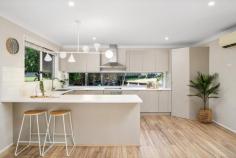 14 Elizabeth St Wyoming NSW 2250 Instant street appeal, beautifully renovated interiors, a lush leafy outlook, and dream al fresco entertaining spaces – this captivating property has it all! Perfectly positioned in a tranquil, tree-lined street within one of Wyoming’s most sought-after neighbourhoods, it’s a fantastic opportunity for families looking to settle in or investors seeking a move-in-ready home with strong rental appeal. Light-filled and stylish, this home has been thoughtfully updated to enhance comfort and functionality. A modern kitchen and stunning bathroom blend contemporary finishes with practical design, while the expansive wraparound deck and fully fenced backyard provide the ultimate setting for kids, pets, and entertaining. Features include: – Three bedrooms, all with ceiling fans; two with large built-in robes. – Stunning family bathroom featuring floor-to-ceiling tiles, a rain head shower, a floating double vanity, and a second WC. – Spacious living areas, including a lounge room with an office nook, plus an open-plan kitchen and dining flowing out to the deck. – Entertainer’s dream deck, offering ample space for outdoor dining and lounging, overlooking the private backyard. – Modern kitchen with an abundance of soft-close cabinetry, a corner pantry, Euromaid appliances (dishwasher, oven, and electric cooktop), a built-in breakfast bar, and a window splashback overlooking the backyard. – Two split-system air conditioning units in the living areas and ceiling fans in all bedrooms for year-round comfort. – Fully fenced backyard, tiered with level grassy areas – perfect for kids and pets. – Established gardens with lush greenery, including tibouchina, hibiscus, lilly pilly, camellia, citrus, and more. – Oversized single lock-up garage. There’s so much to love about this incredible home! Plus, this coveted location offers easy access to all the conveniences of Wyoming (local schools, shops and public transport), Gosford (CBD, waterfront, hospital, and train station), and the lifestyle benefits of the Central Coast, including a selection of beautiful beaches. For those needing to commute, the M1 is within easy reach for travel to Sydney or Newcastle.