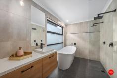 2 Rheola Drive White Hills VIC 3550 $795,000 - $850,000 Welcome to 2 Rheola Road, White Hills - an HIA award winning home that combines modern luxury with effortless family living. This stunning ex-Sandhurst display home, which won Best Display Home, presents the perfect opportunity to upsize into a stylish, low-maintenance property, offering everything you need to live stylishly in modern surrounds. Located just 5 minutes from the Bendigo CBD and a short 4-minute drive to the beautiful Bendigo Botanic Gardens, you're positioned in a prime location that provides both convenience and tranquility. Whether you're commuting, shopping, or enjoying a leisurely afternoon in the gardens, everything is at your doorstep. Entering onto spectacular polished concrete floors, the entry leads you to the aesthetic heart of the home with 3m high soaring ceilings. The contemporary matte black kitchen is a standout with its sleek 900mm appliances, built in appliance cupboard, standalone double pantry, 40mm stone benchtops and feature stone splashback. An impressive extra walk-in pantry fitted out with custom joinery and matching stone tops gives the kitchen a superb prep space. The 3.0-meter-high ceilings through the main living areas of the house elevate the sense of space and openness, giving the entertaining spaces, rear bedrooms and bathroom a soaring sense of grandeur and natural light pours in through the triple skylights above. The master suite is nothing short of luxurious, with luxury carpets, a crafted joiner-built walk in robe and generous ensuite featuring his and her basins and his and her open showers. A freestanding bath is ideal for relaxing after a long day. For added versatility, the home features a second lounge room, ideal for a kids' playroom or a quiet retreat for the adults. Throughout the home, you'll find expansive storage solutions, keeping your space organised and clutter-free. Ducted gas heating and cassette cooling ensure year-round comfort, no matter the season. The stunning main bathroom, with its opulent circular tub and floor-to-ceiling tiles, adds a touch of elegance to this already exquisite home. The laundry features abundant built-in joinery, whilst bedrooms 2, 3, and 4 are all spacious and equipped with built-in robes, all punctuated by those amazing 3m high ceilings. The north facing alfresco features a beautiful merbau deck and the garden is fully established and low maintenance, with auto irrigation and artificial turf allowing you to sit back and simply enjoy the stunning landscaping. The garage is currently converted to a rumpus room/office space with private WC, a great addition if you wish to work from home or need that extra living area. Or if preferred, the seller will swap out the large glass sliding door for a garage door at no cost. There is rear street access available if you'd prefer to park directly in the back yard. With its blend of architectural design, spacious living areas, and premium features, this home is the perfect place to create lasting memories with your family. Whether you're relaxing at home or exploring all that Bendigo has to offer, 2 Rheola Drive is the ideal setting for your new lifestyle.